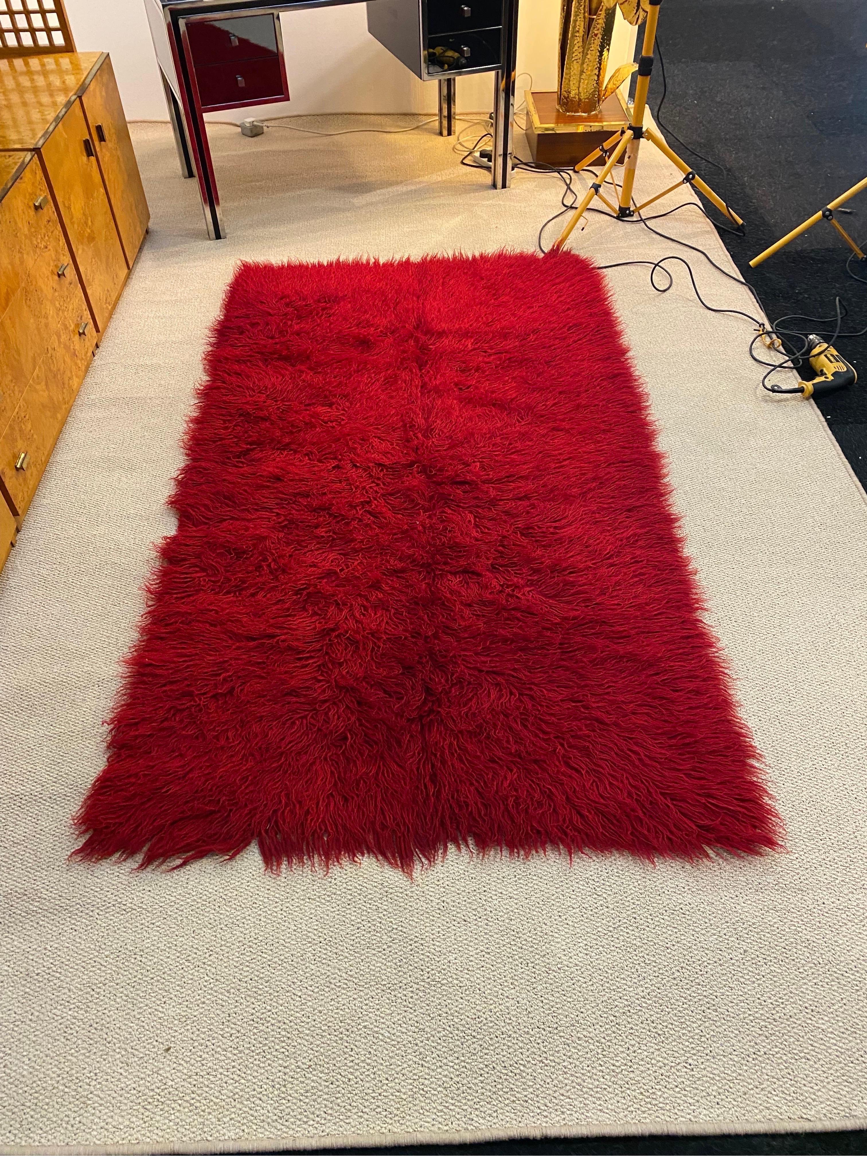 A beautiful and fluffy rug made in the 1950s as part of a girls dowry and passed on to the next generations. 
It is made out of pure wool, hand dyed naturally and weaved to give this effect. Its a piece of folk art, these pieces were used either on