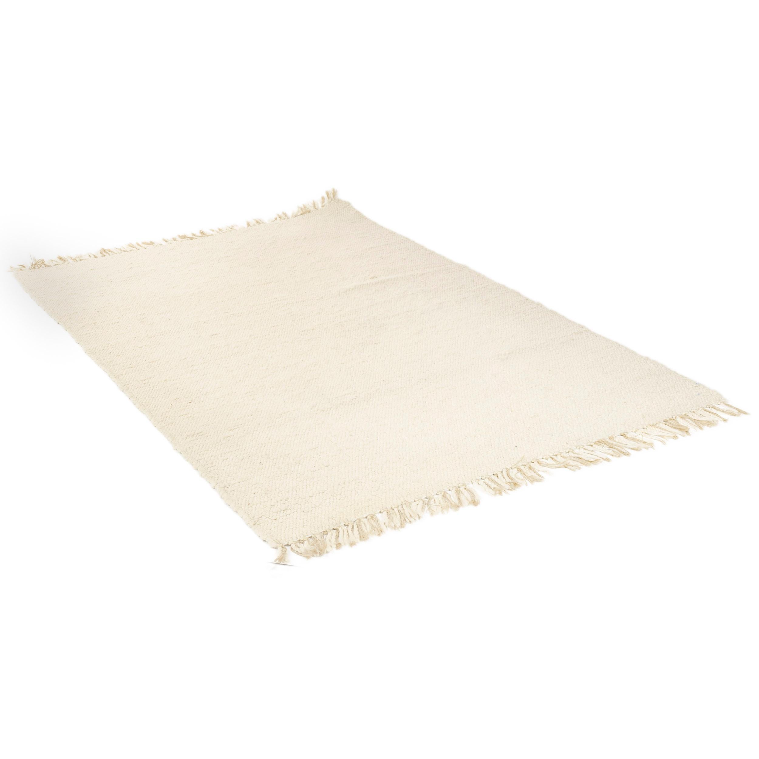 An off-white wool twist-yarn rug, woven on a loom and finished with hand knotted wool and hemp ties.
