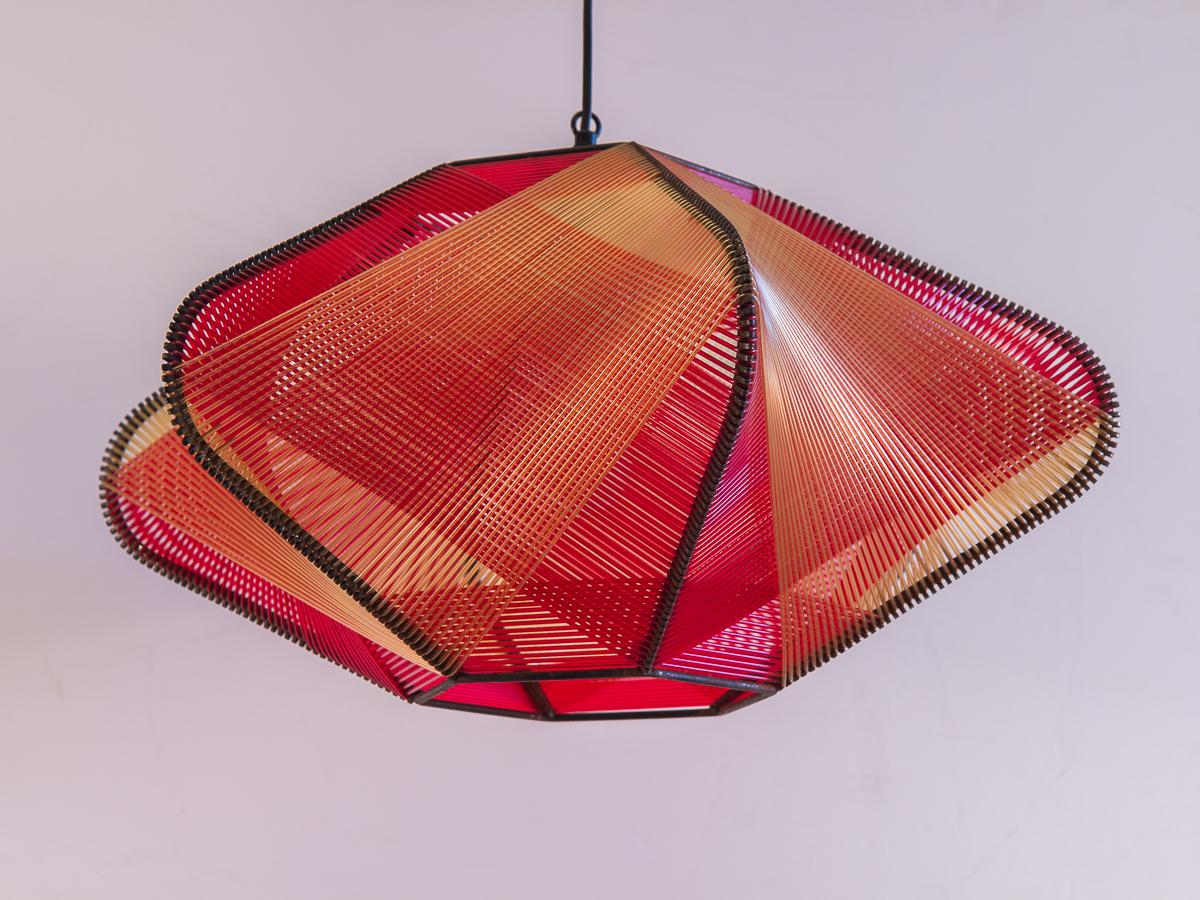 Vintage 1960s Woven string Art Pendant. Red and yellow acrylic filament are woven to create the curving planes on this six-sided star. A stellar light sculpture that will grab your attention at every angle. In perfect working condition.