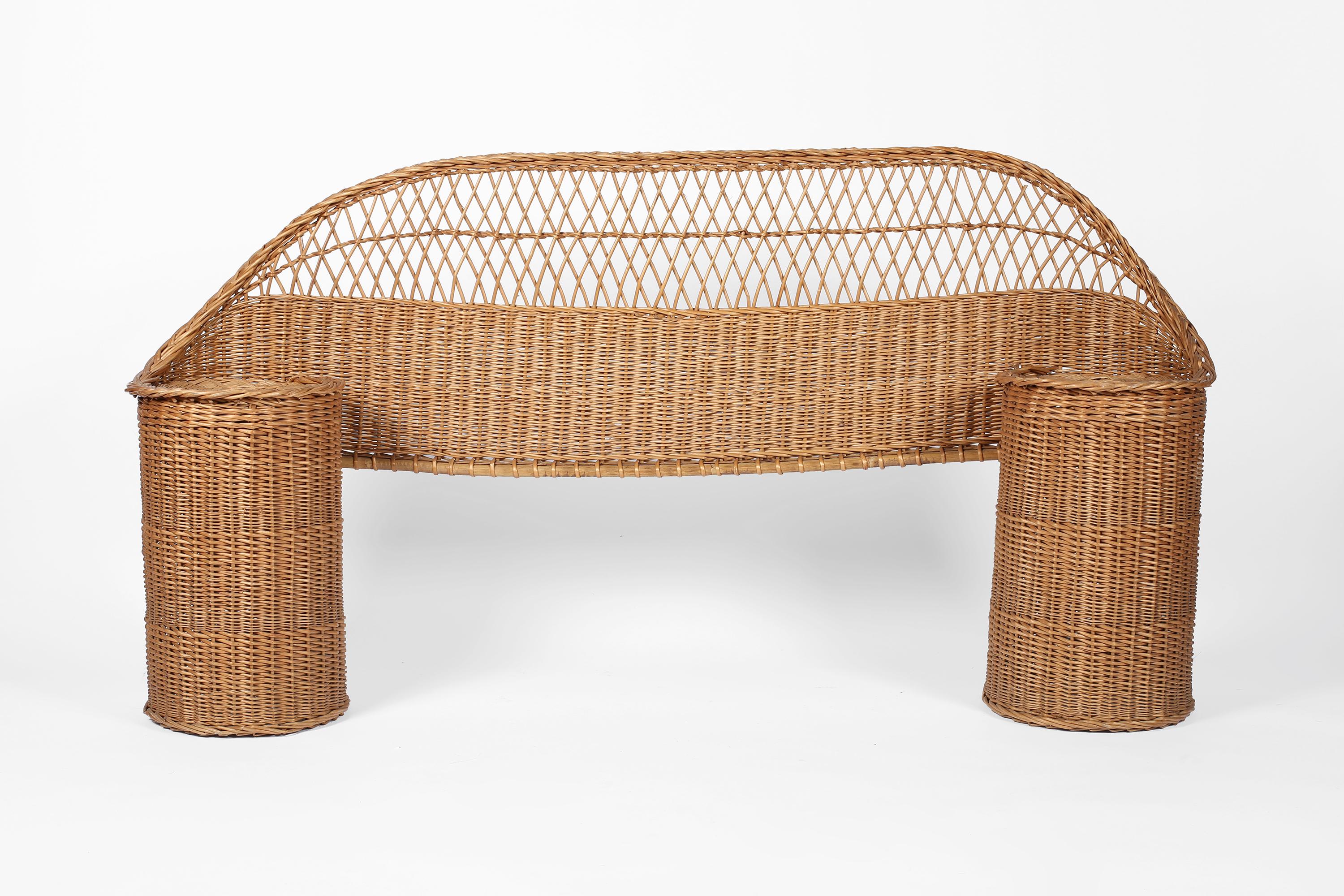 A single woven wicker headboard from Provence, with integrated circular bedside tables. French, c. 1960s.

Between bedsides 100cm.