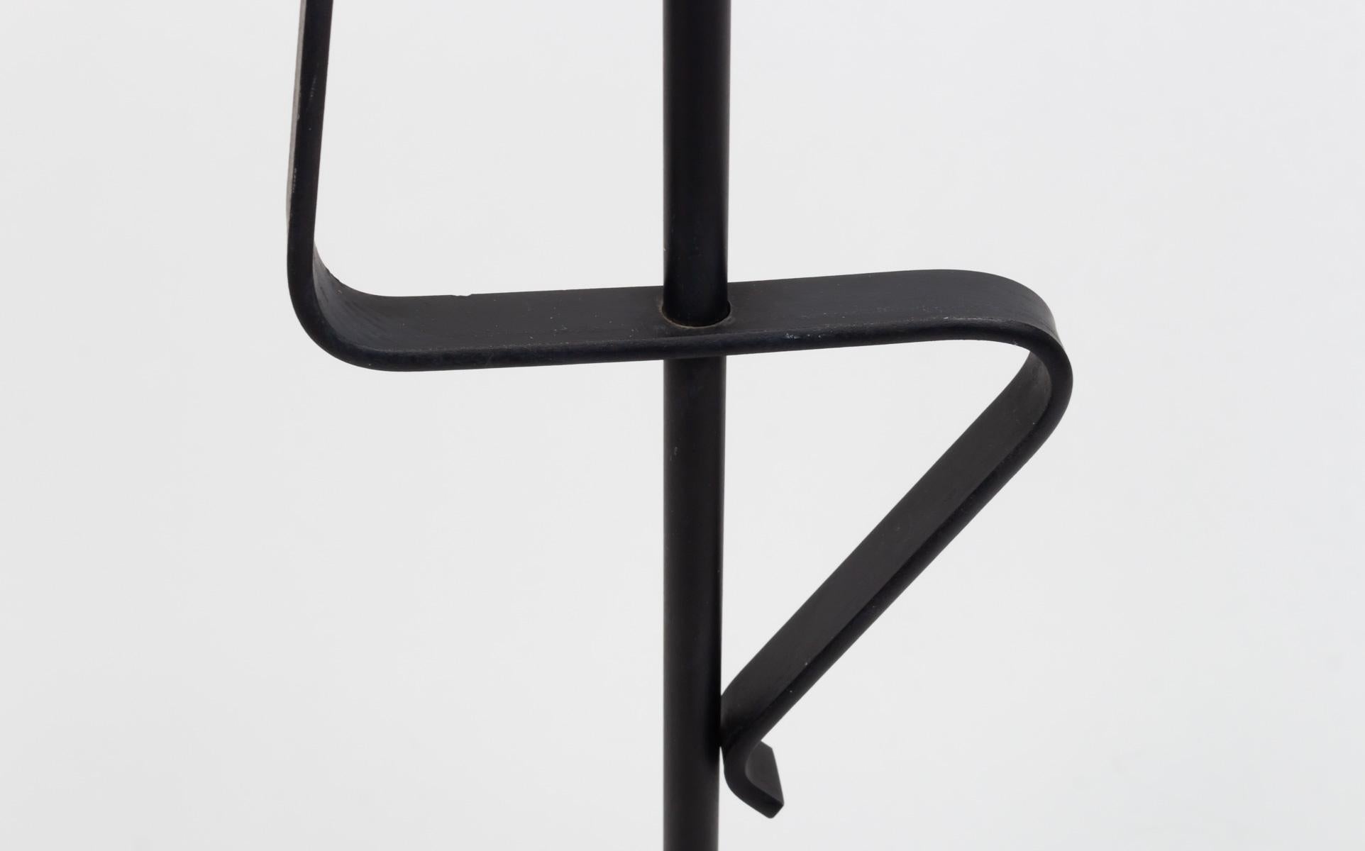 Mid-century black wrought iron floor lamp. Abstract creation with typical shapes of the 60s. See the ingenious base, designed with great minimalism. Tall cylindrical shade. two bulbs whose sockets can be brought up to the standards of your country.