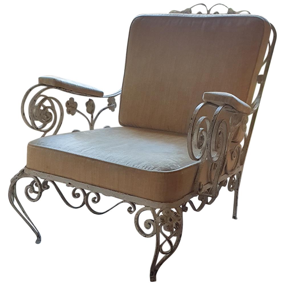 This is a beautiful and characterful 1960s Wrought Iron Orangery Lounge Chair with scrolling arms, legs and back rest detail interspersed with hand pressed iron flower details
The chair is made of handwrought iron in its original paintwork which