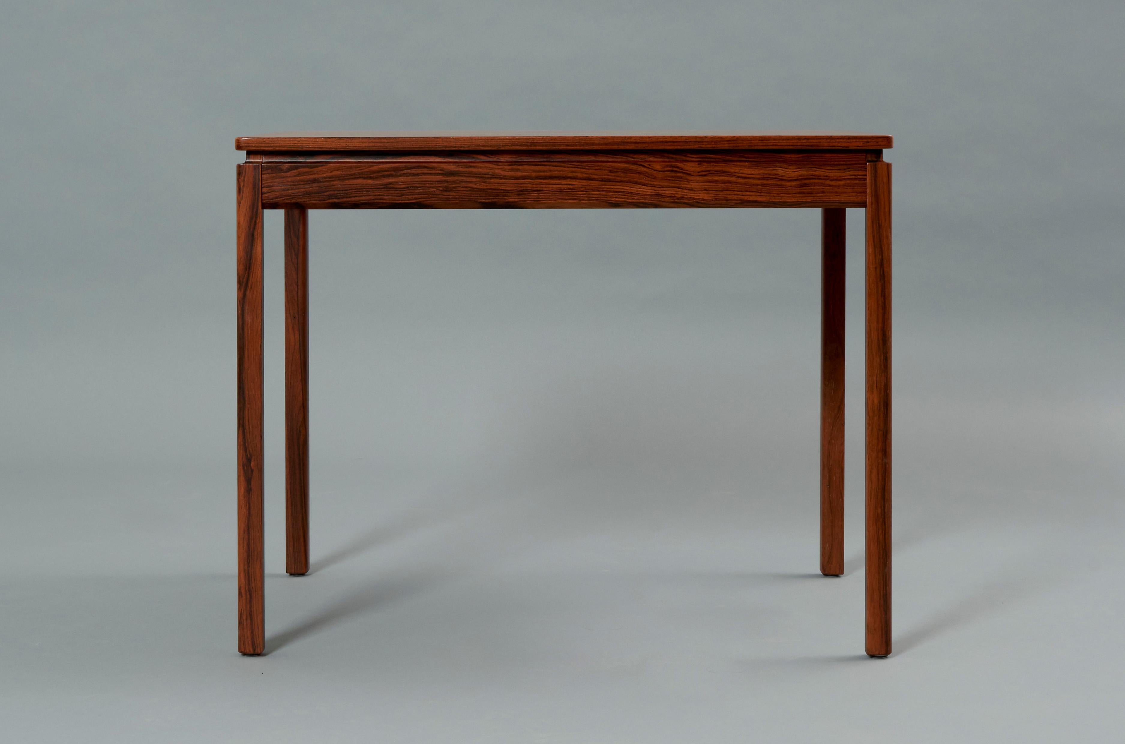 Side table designed by Yngvar Sandström for Säffle Möbelfabrik in Rosewood. 
This is an excellent example of Mid century design featuring simple lines, carefully detailed and rich materials that give this table an overall elegant and refined