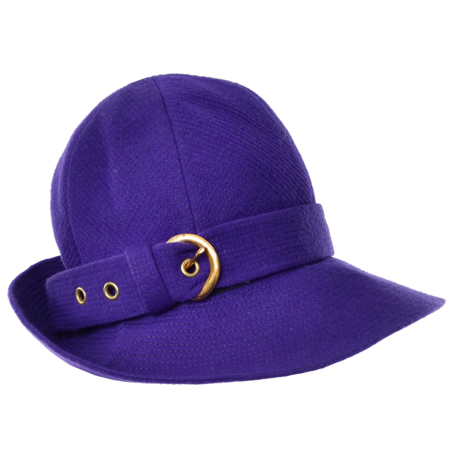 This is an incredible vintage Yves Saint Laurent  purple wool hat with a buckle on the side and a wide front brim.  This fabulous vintage YSL hat measures 22