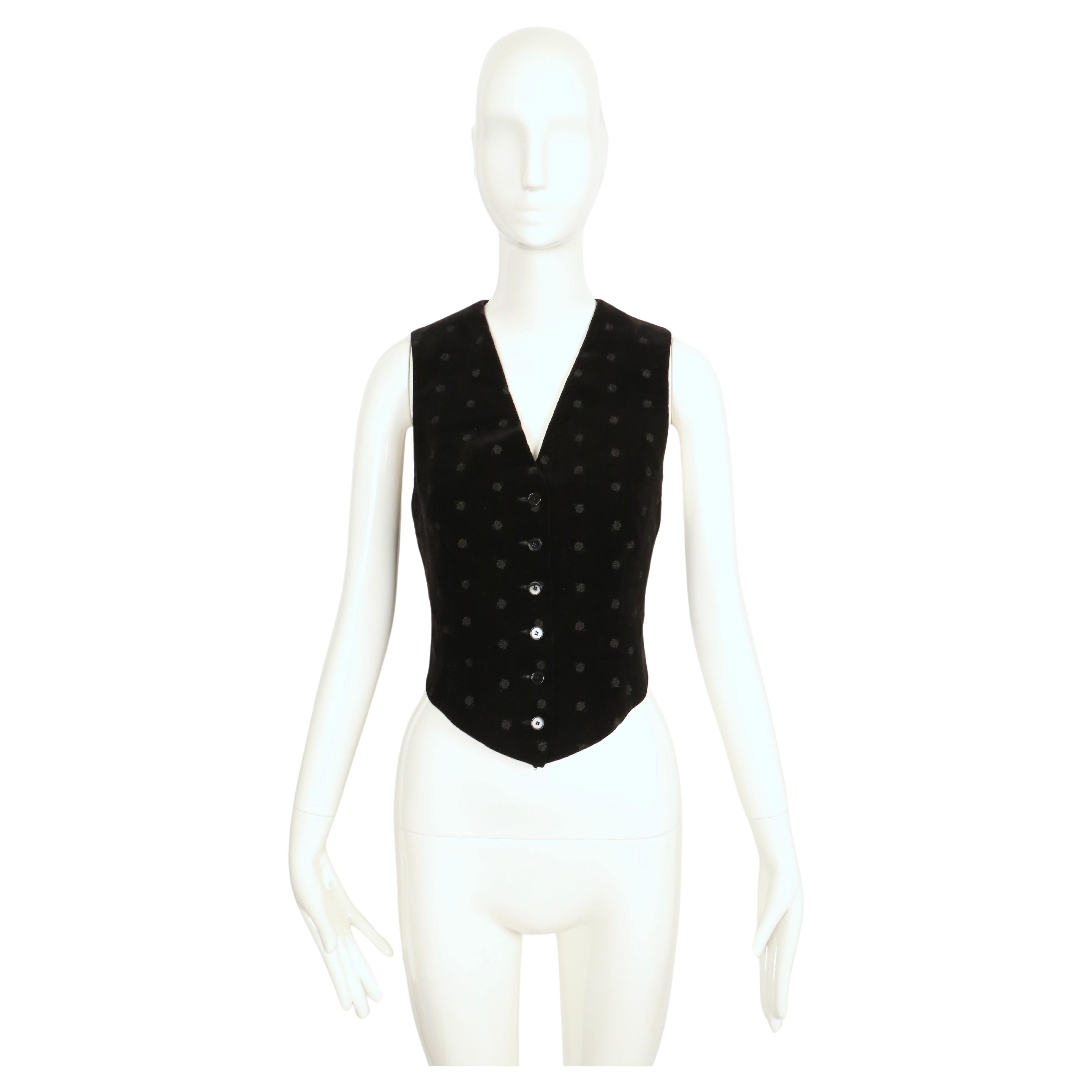 Very rare black floral embroidered velvet vest designed by Yves Saint Laurent dating to the late 1960's. Vest is labeled French size 40 although it fits very small and would best fit a FR 36 or US 2 or 4. Approximate measurements are as follows: