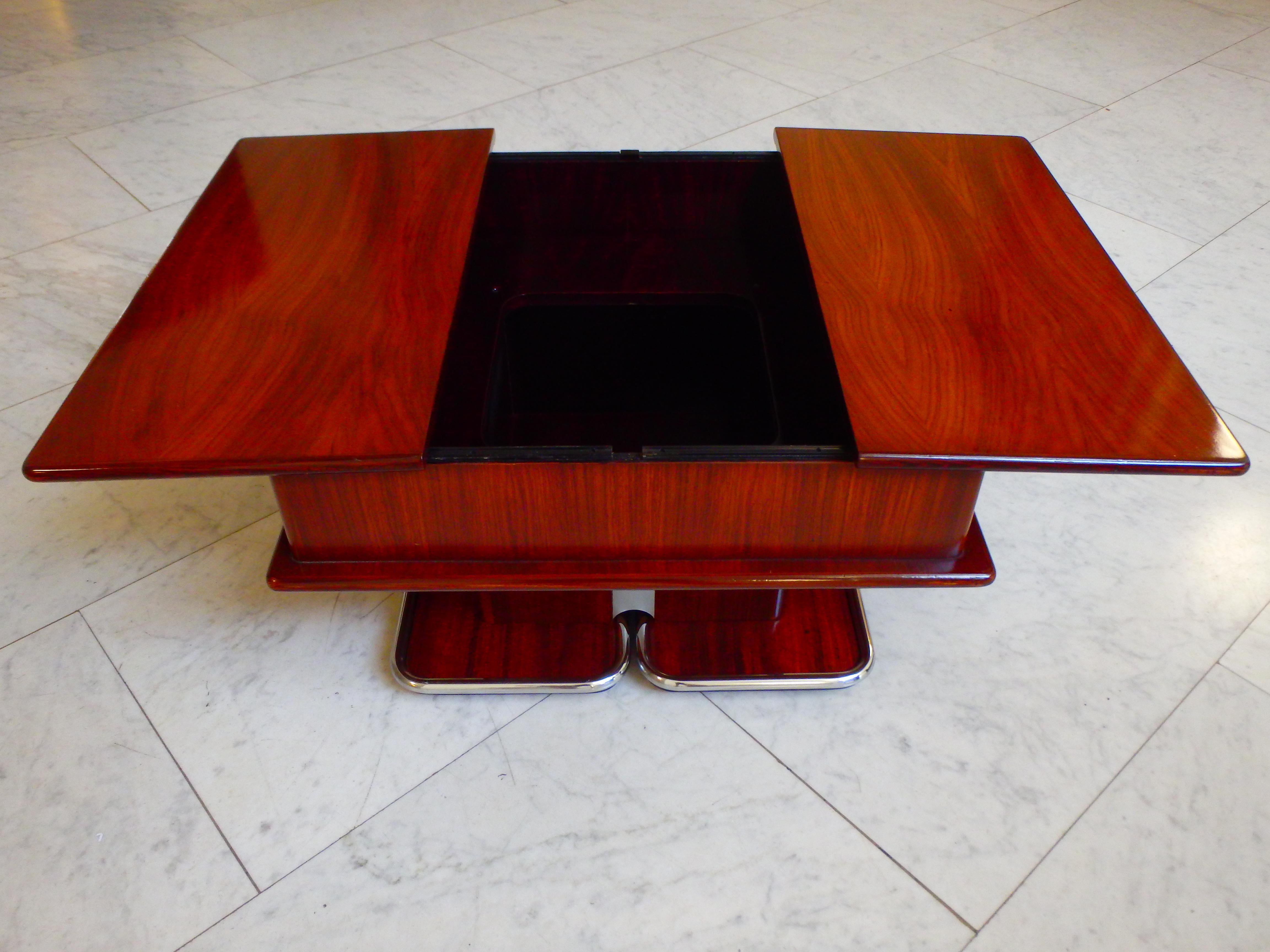 1960this bar table with opening for bottles and glasses on wheels with chrome.