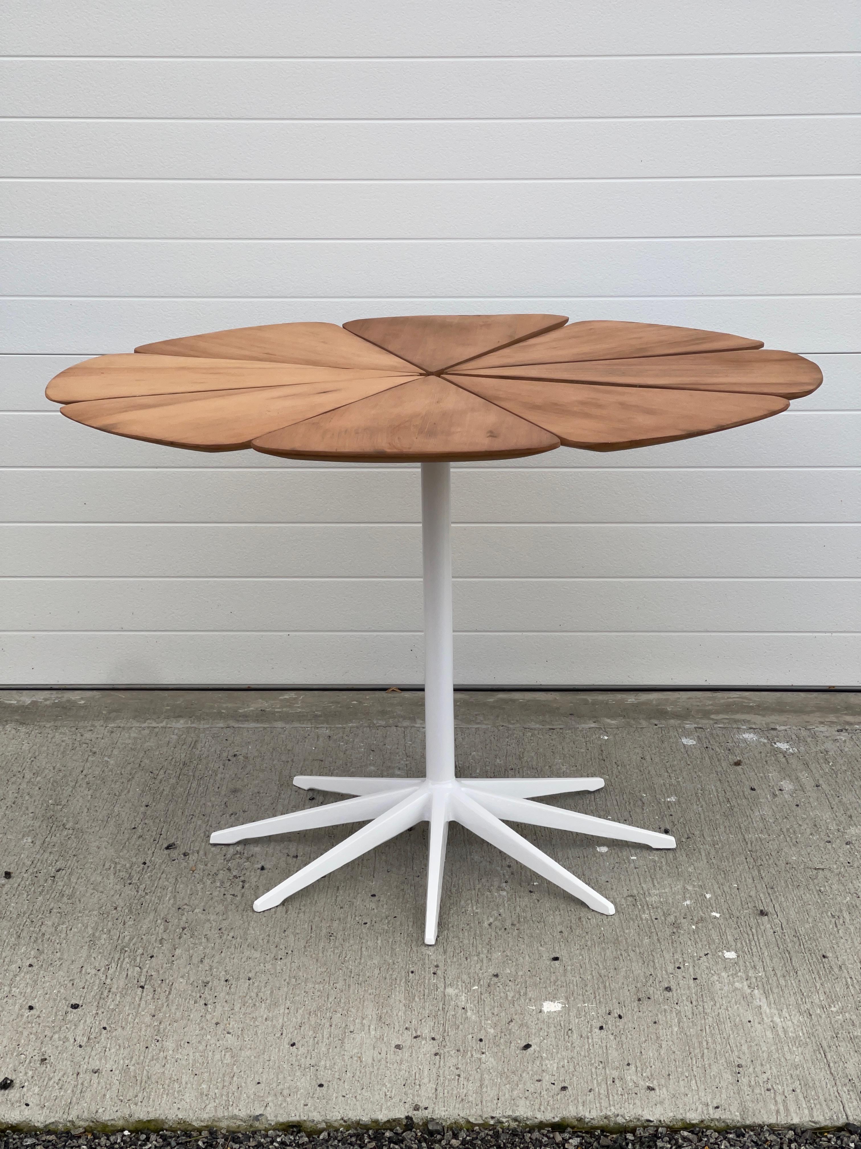 This is one of the earliest editions of the Petal table designed by Richard Schultz and produced by Knoll circa 1961.
It was supplied from Knoll with the petal tops painted white (see last photo) but the underlying wood is California Redwood. (Later