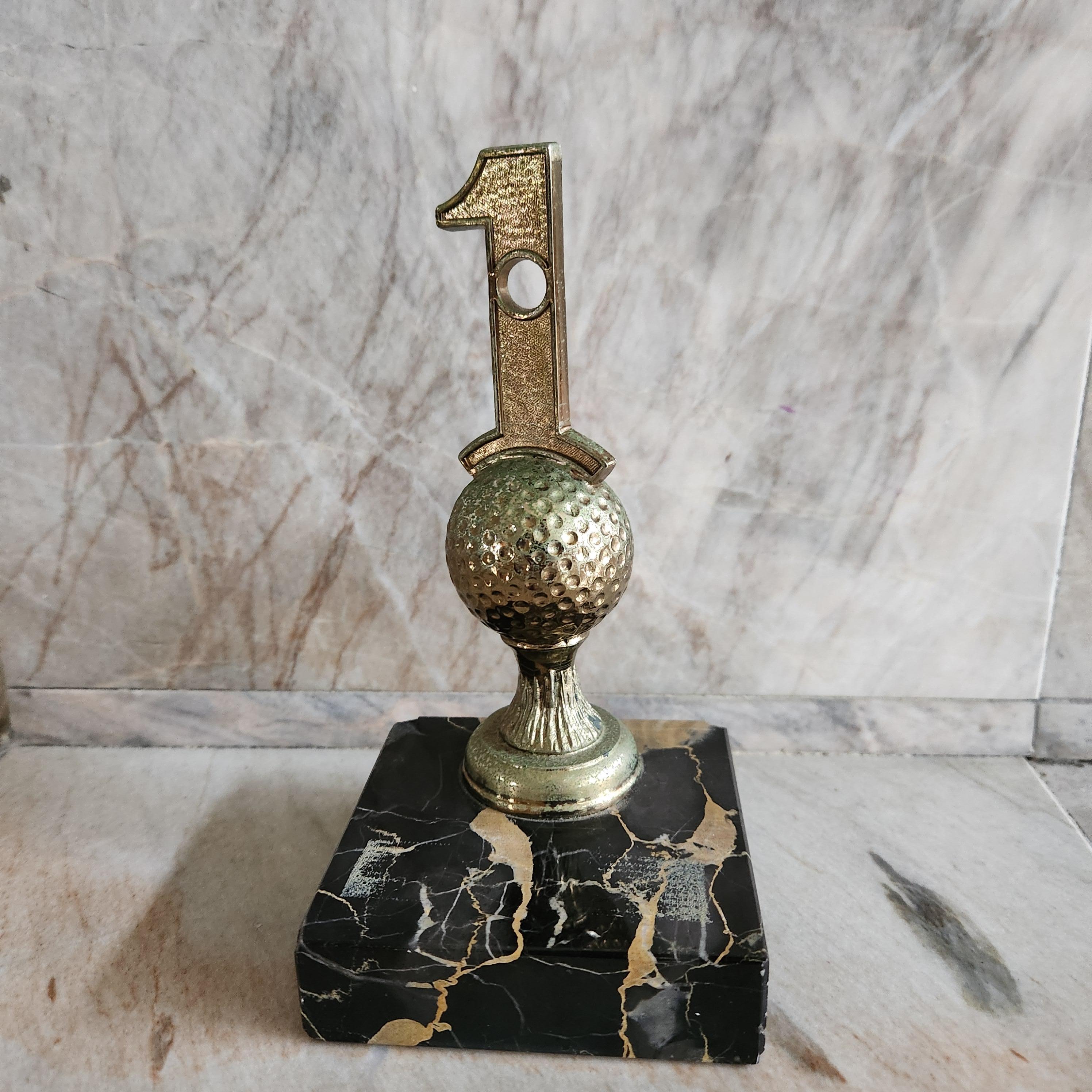 1962 Gold Hole in One Trophy on Black Marble Base Bookend
3.5 x 3.5 x 7 tall
Preowned original unrestored vintage condition
ghost label remains as well as chips on base finish
Refer to images listed please