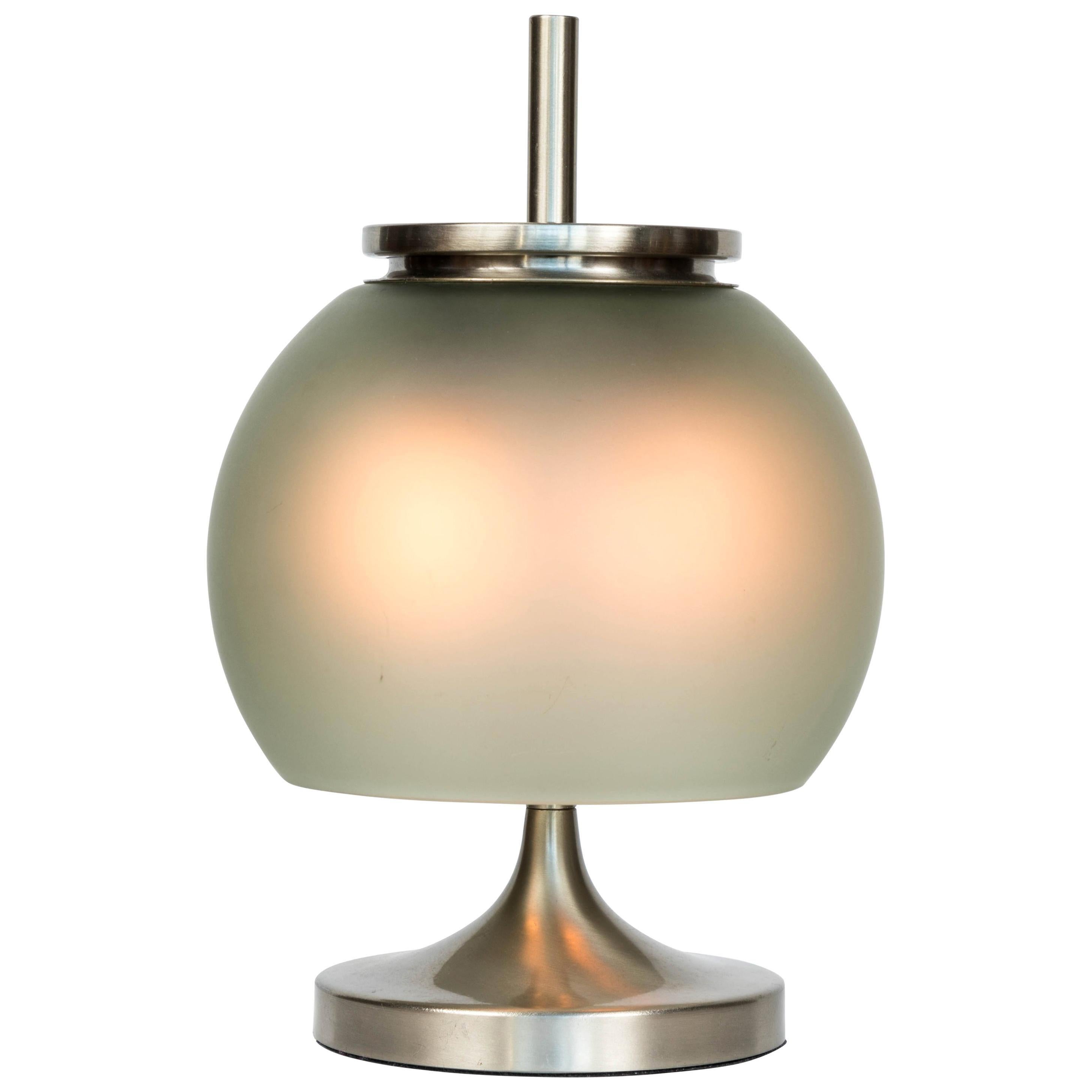 1962 Emma Gismondi Schweinberger 'Chi' table lamp for Artemide. This uniquely elegant table lamp is produced in nickeled brass and hand blown green opaline glass. An highly refined and iconic midcentury design that is quintessentially Italian. Two