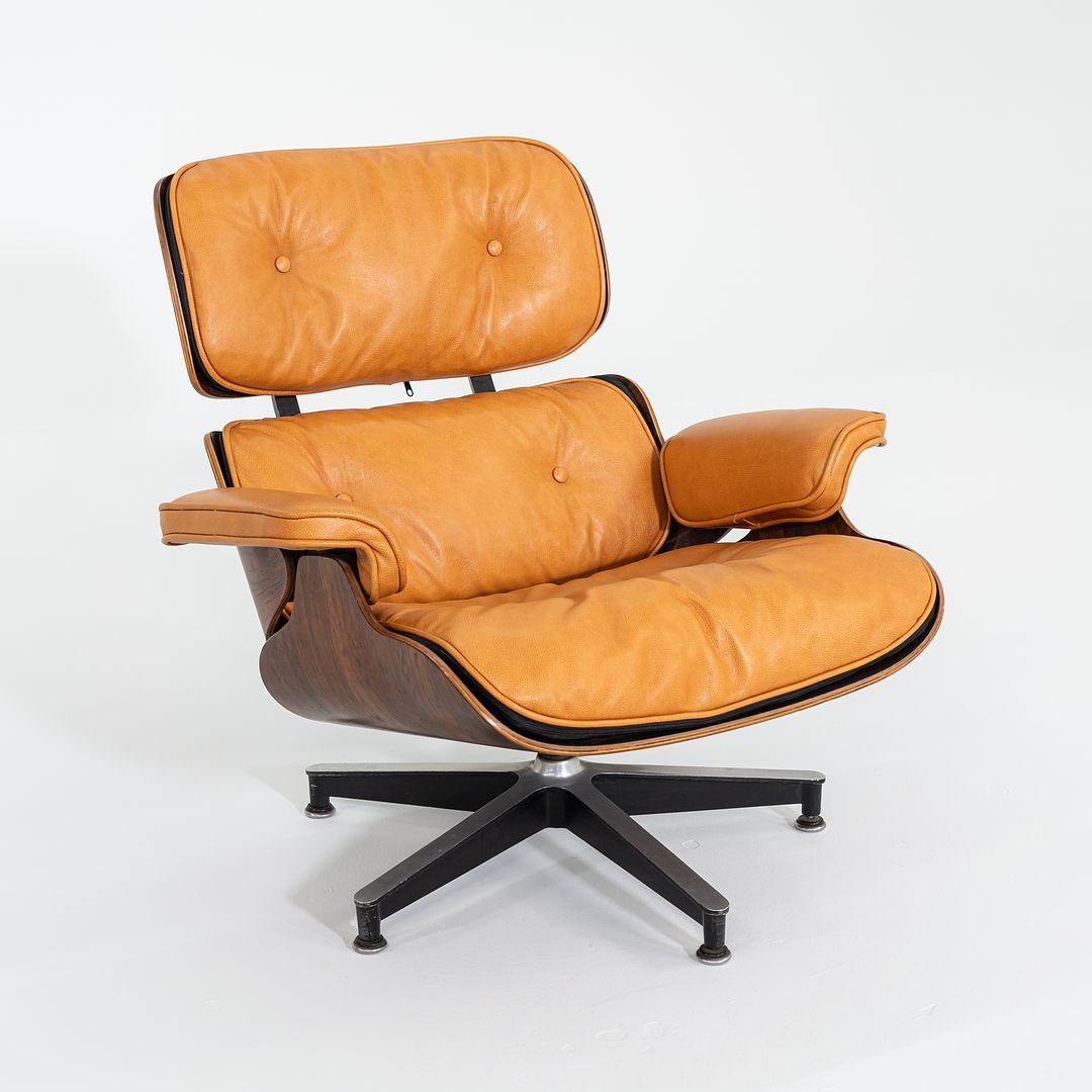 This is an original Eames Lounge Chair and Ottoman, models 670 and 671, designed by Charles and Ray Eames for Herman Miller in 1956. This set dates to 1962. The shells on this set are composed of Brazilian Rosewood, and the upholstery has been