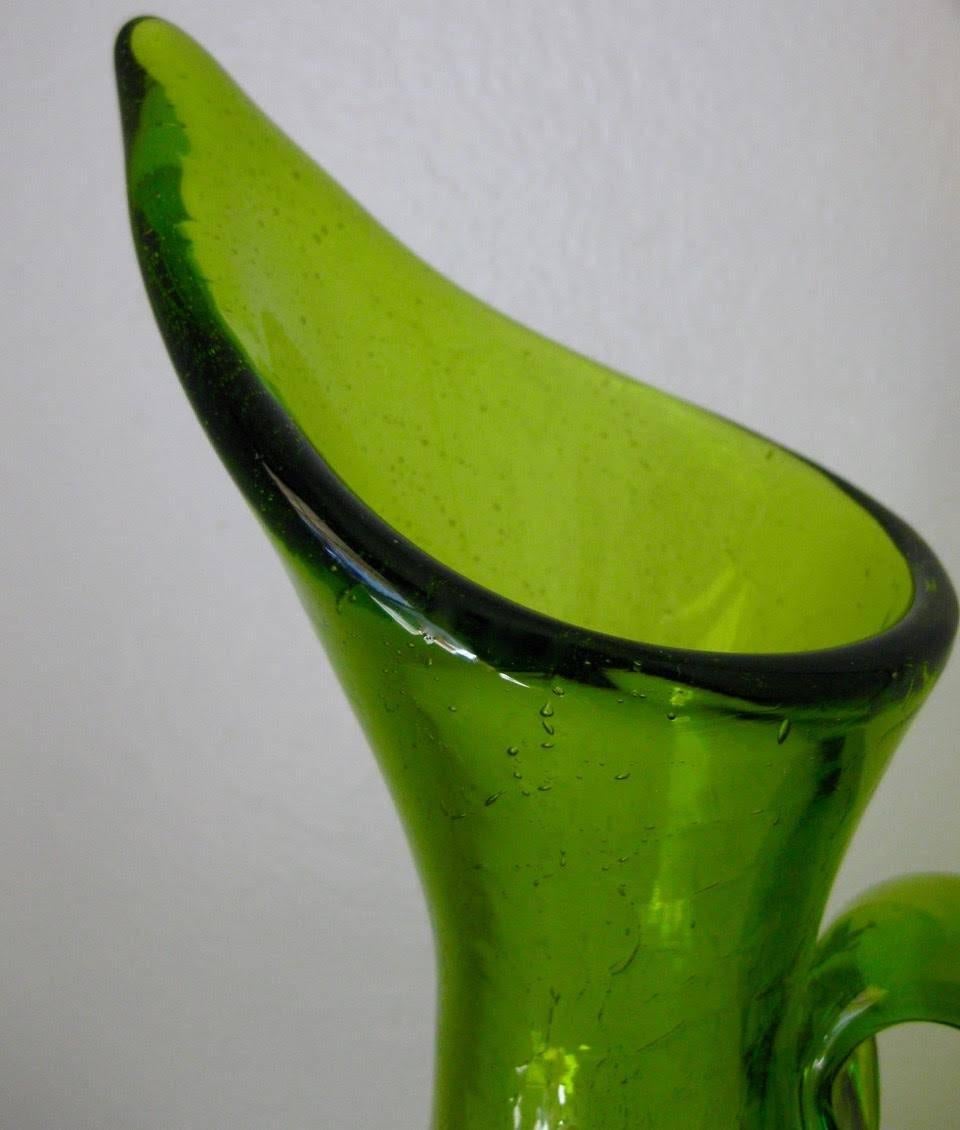 Stunning tall, crackle-finished #976 pitcher in kiwi green. Designed by Winslow Anderson for Blenko glass in 1963.
 