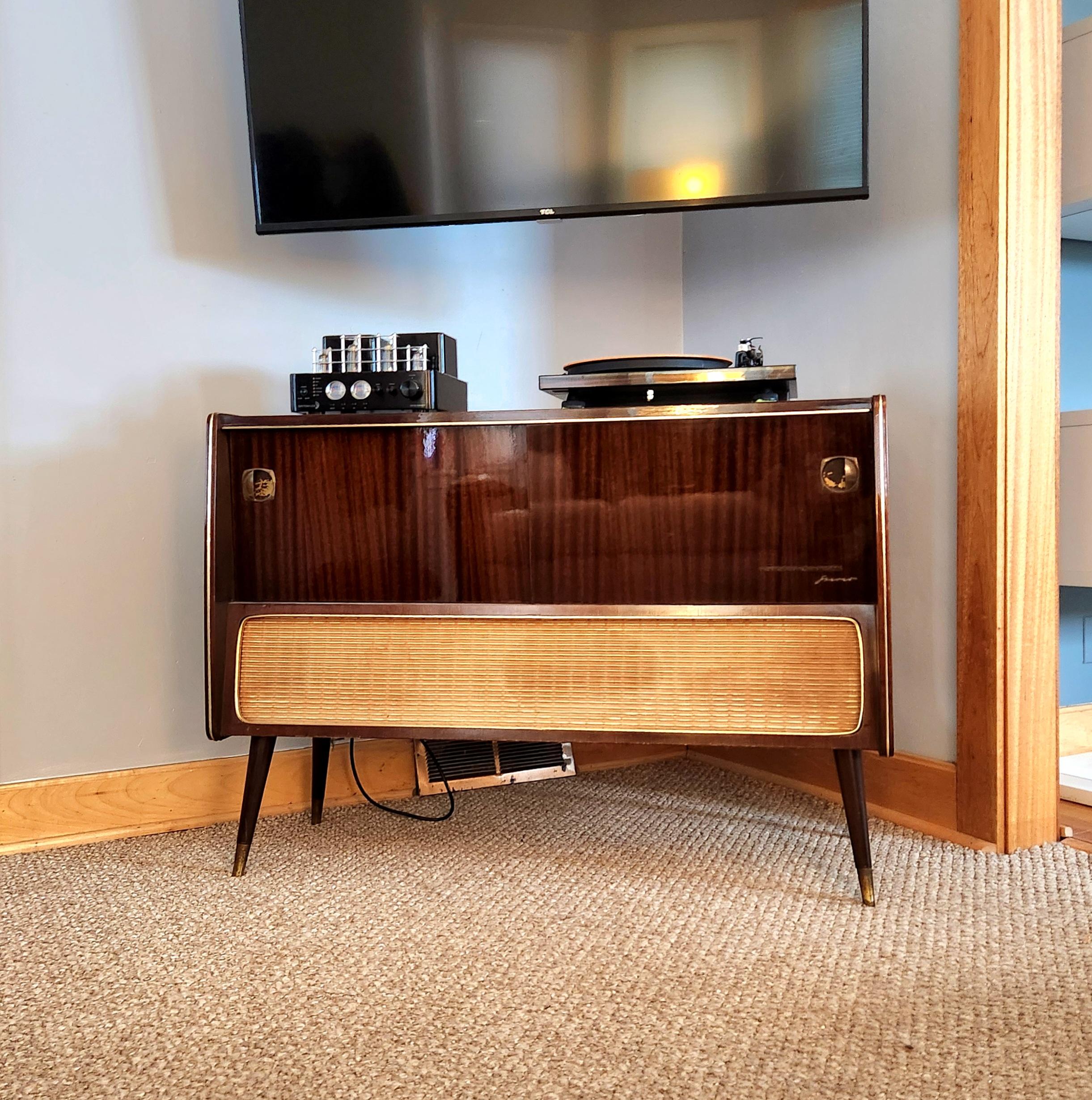 “If art decorates space… and music is the art that decorates time, then our vintage stereo consoles decorate lives by accentuating both.”  Groovy Wood Studios

This console:
This is a console refurbished by Groovy Wood Studios.  We acquire our