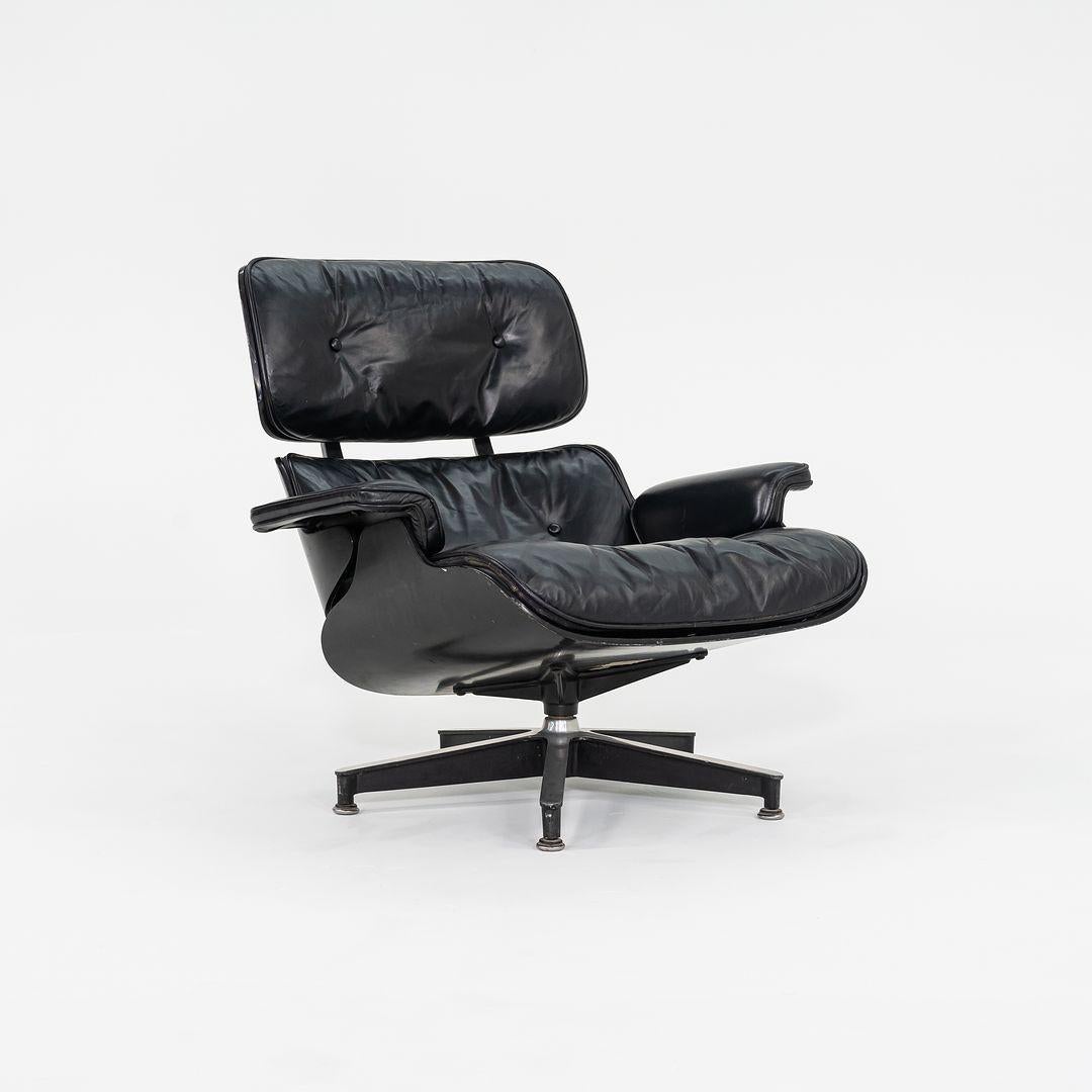 This is an original Eames Lounge Chair and Ottoman, models 670 and 671, designed by Charles and Ray Eames for Herman Miller in 1956. This set dates to 1963 and appears to have been a custom order, having black ebonized wood panels, which we have