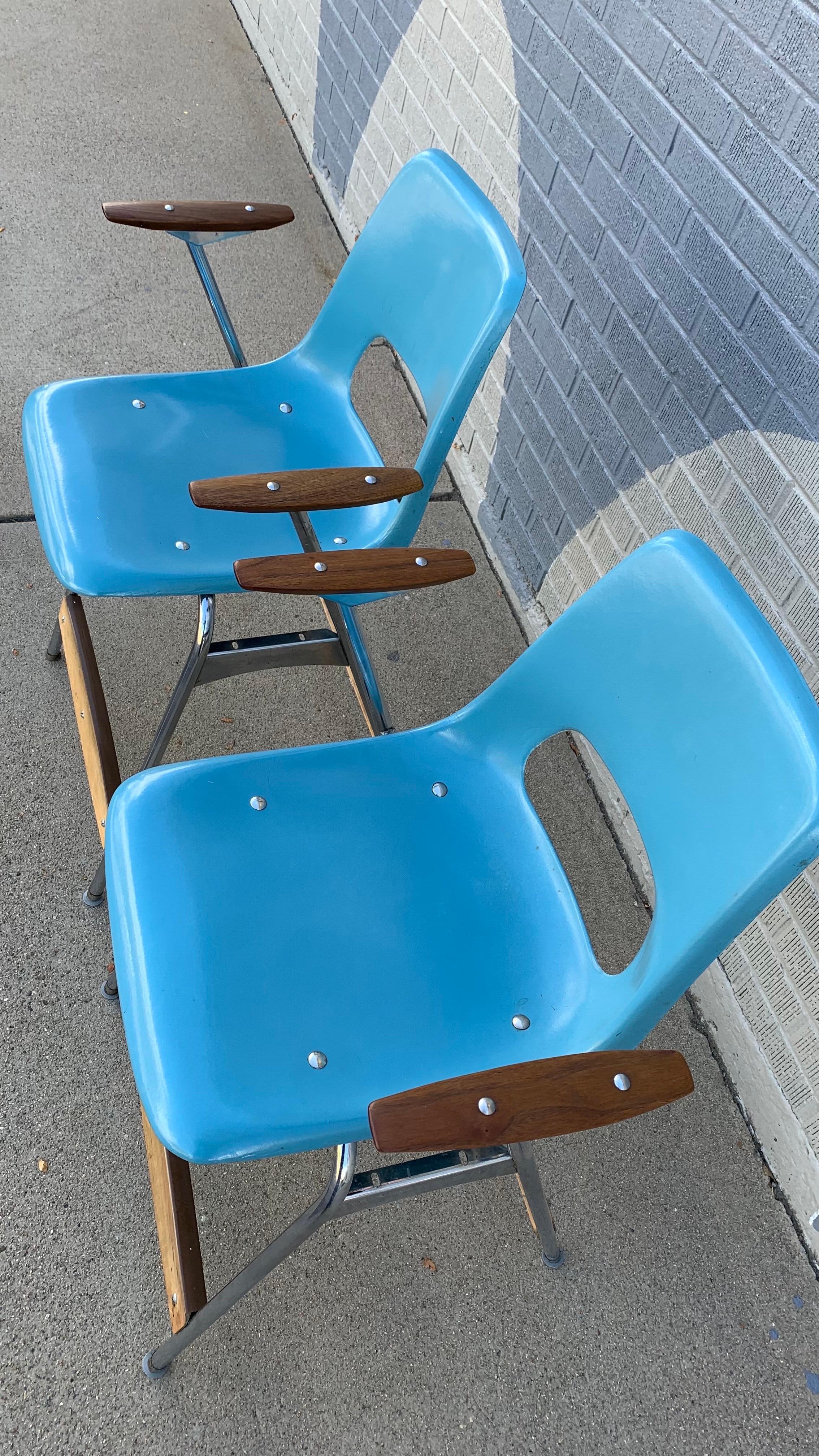 Bring a dose of retro charm into your space with this pair of vintage Brunswick counter-height stools. Featuring vibrant molded blue fiberglass seats with signature cut-out backs, these stools embody mid-century industrial style with a playful edge.