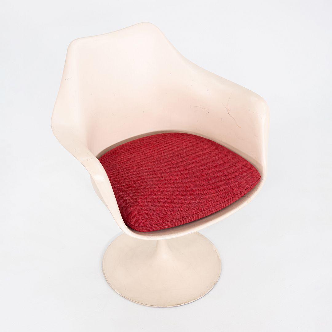This is a Saarinen Tulip Pedestal Swivel Armchair, Model 150A, initially designed by Eero Saarinen for Knoll in 1956. This particular example dates to 1964, which is dated on the underside of the chair. The design features a sculpted tulip-like base