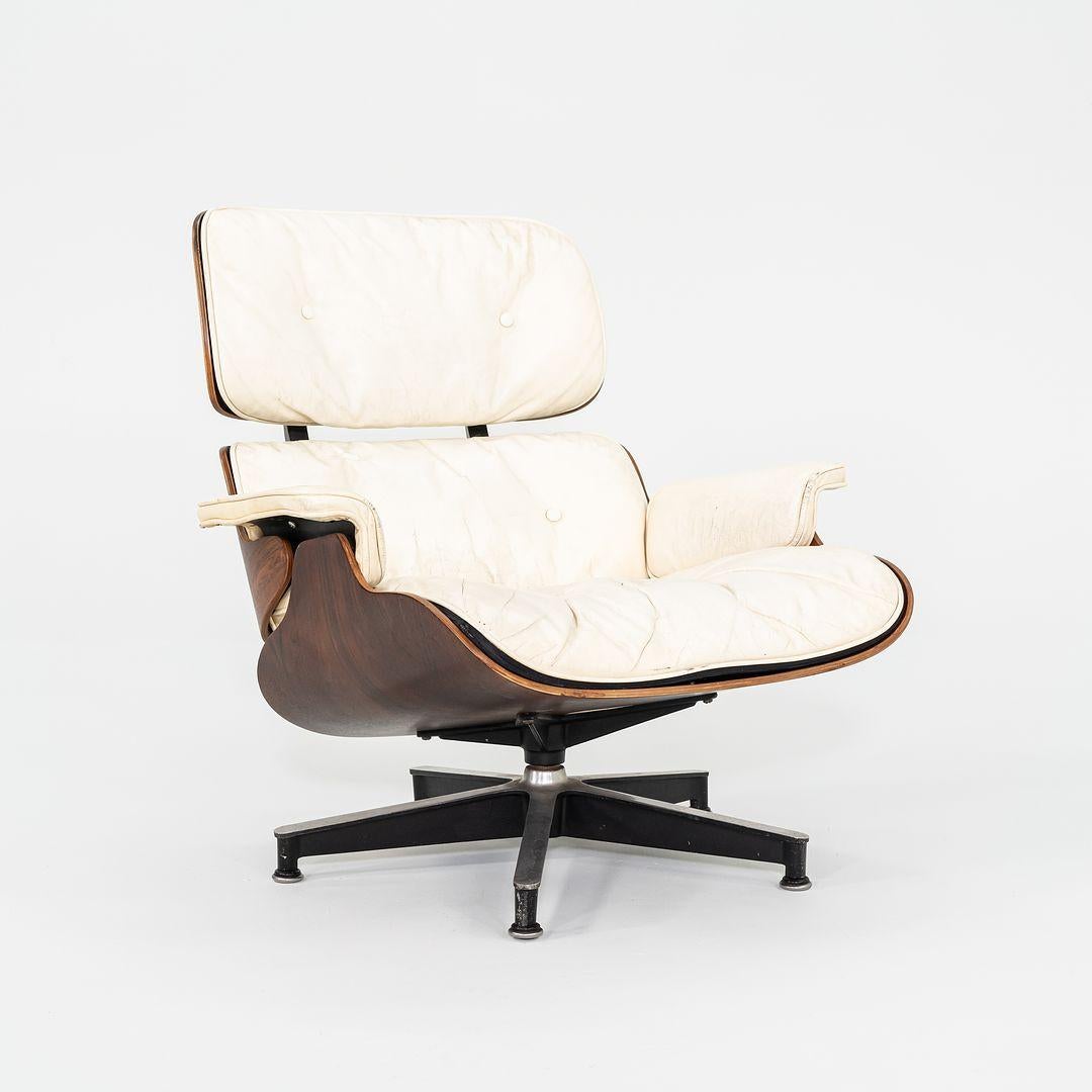This is an original Eames Lounge Chair and Ottoman, model 670 and 671, designed by Charles and Ray Eames for Herman Miller in 1956. This set dates to 1964, per its label. The shells on this set are composed of Brazilian Rosewood, and the upholstery