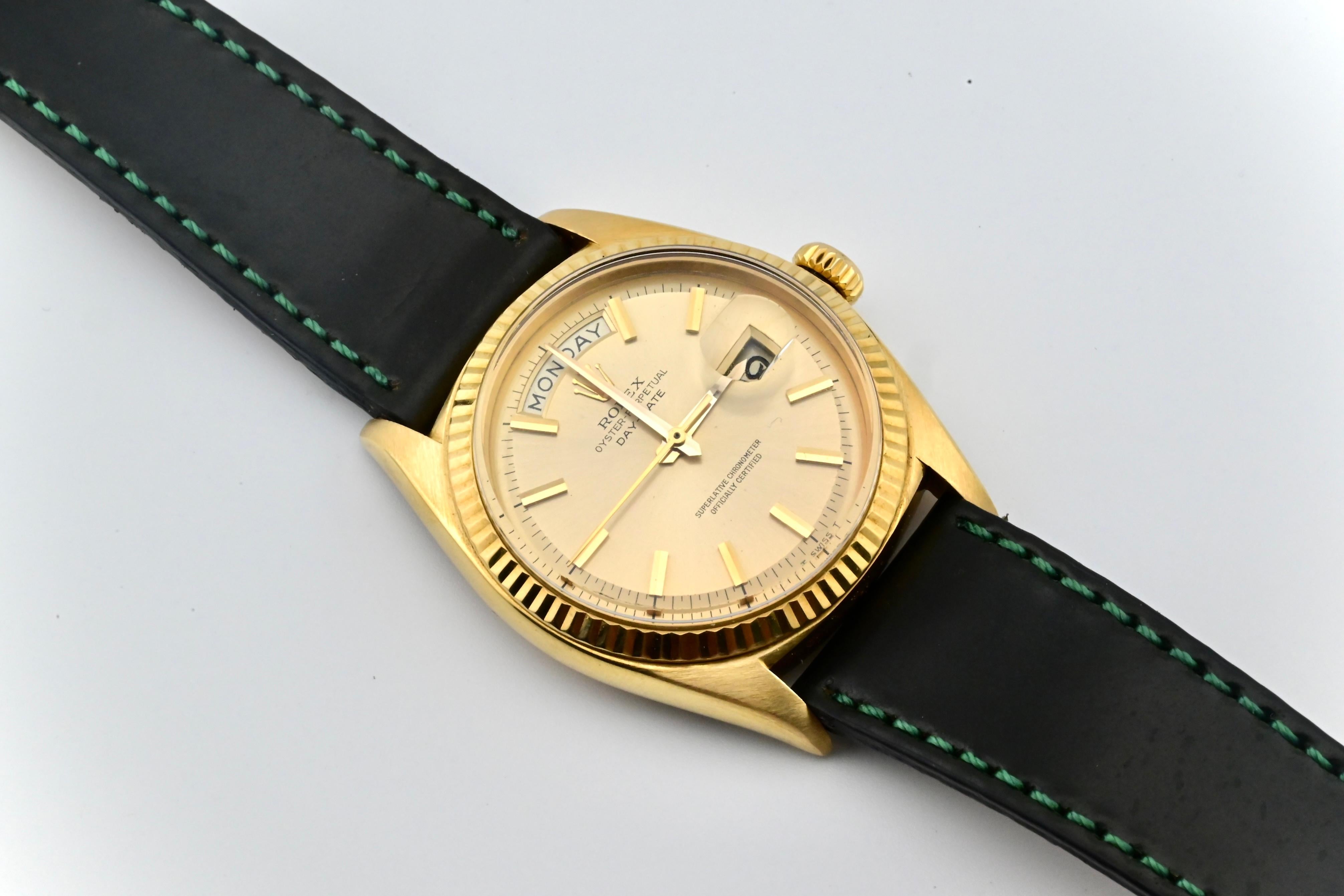 This is a rare and fabulous vintage 1965 18K yellow gold Rolex Day-Date 1803 with a double-hyphen dial. It comes with both the watch, and the strap. The strap length is 9 1/2 inches, and the watch weighs 65 grams. The case diameter is 36mm, the case