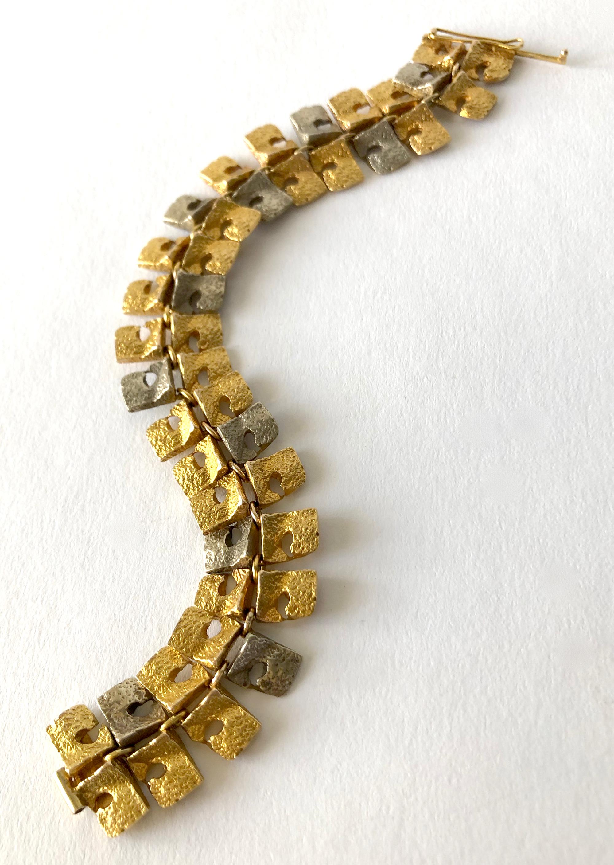 Textured white and yellow 14k gold linked bracelet created by master sculptor and jeweler Bjorn Weckstrom of Helsinki, Finland.  Bracelet measures 7.5