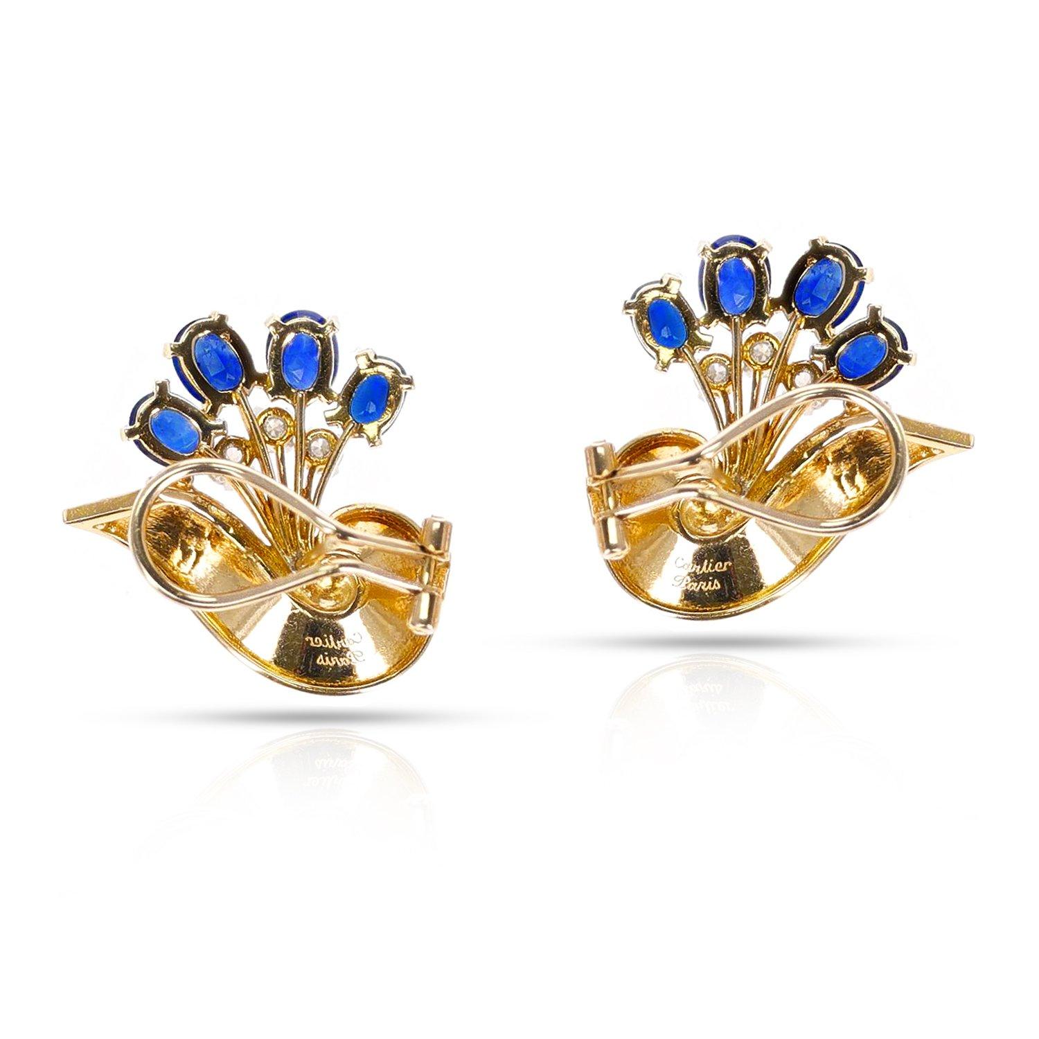 An elegant pair of Sapphire and Diamond 18K Yellow Gold Earrings by Cartier, Paris. These exquisite vintage treasures, crafted in the heart of Paris, France, by skilled artisans, bear the prestigious Cartier name that is synonymous with luxury and