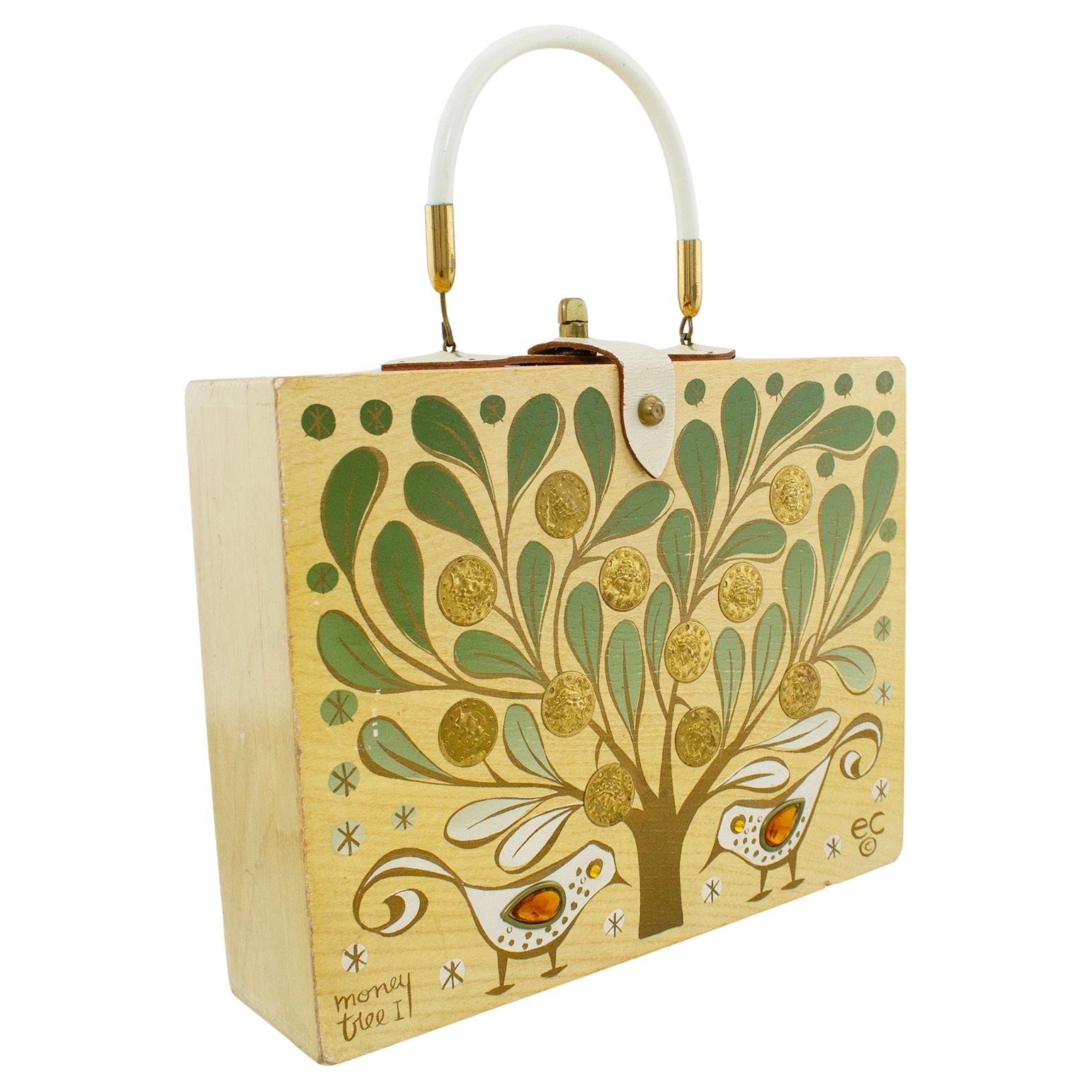 Enid Collins 1965 'Money Tree' Original box bag. Light wood background, hand painted with coin and jewel appliqué. Has a brass turn lock on an off white leather latch with matching off white hard handle. Minor wear to the bottom edge, minor