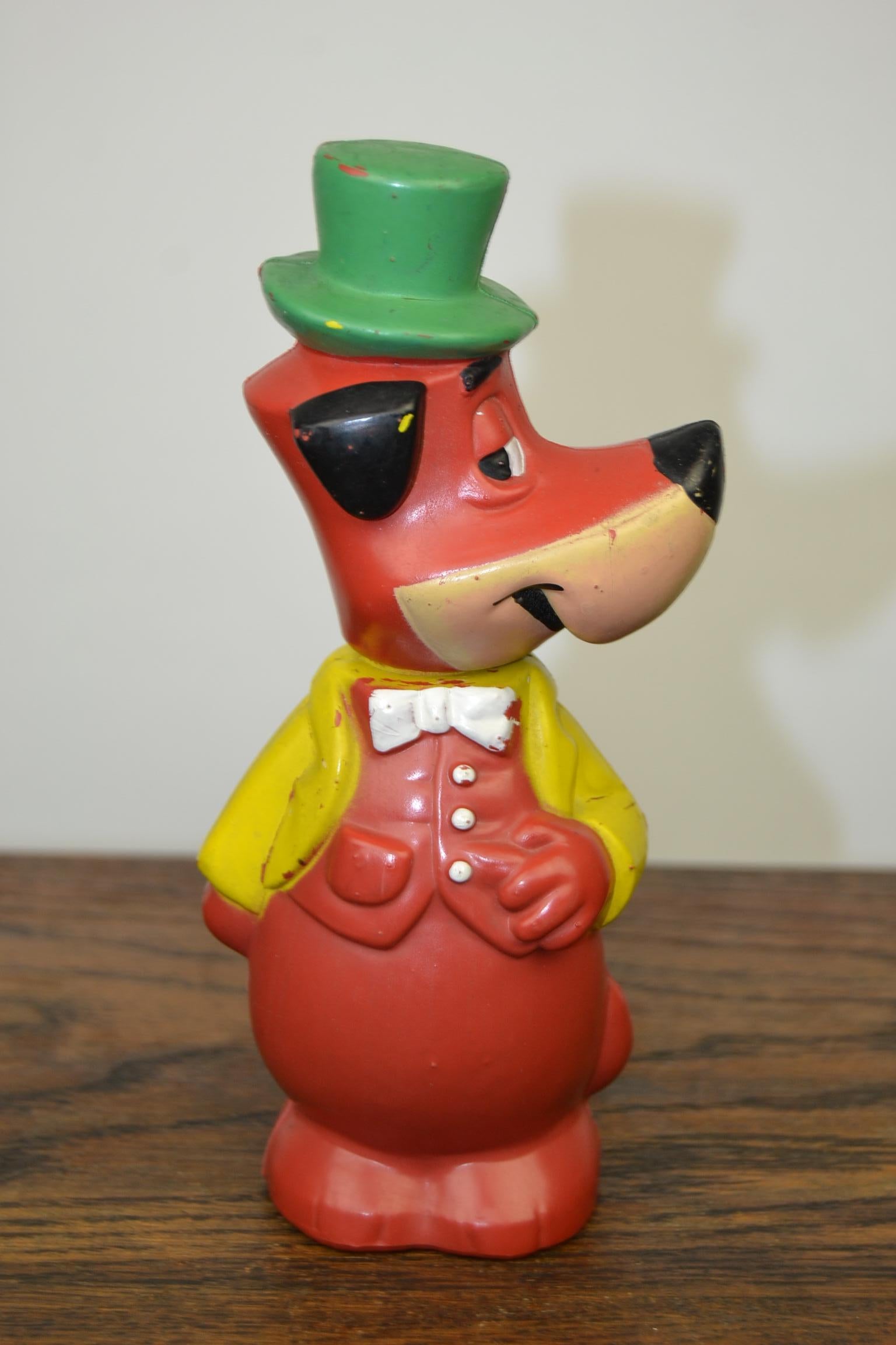 Nostalgic toy figurine, the Huckleberry Hound.
This Animation movie character was created by Hanna- Barbera Productions.
The rubber toy dog was made in 1965 by W.Goebel - Western Germany.
This 1960s vintage squeeze Toy has a movable head, a green