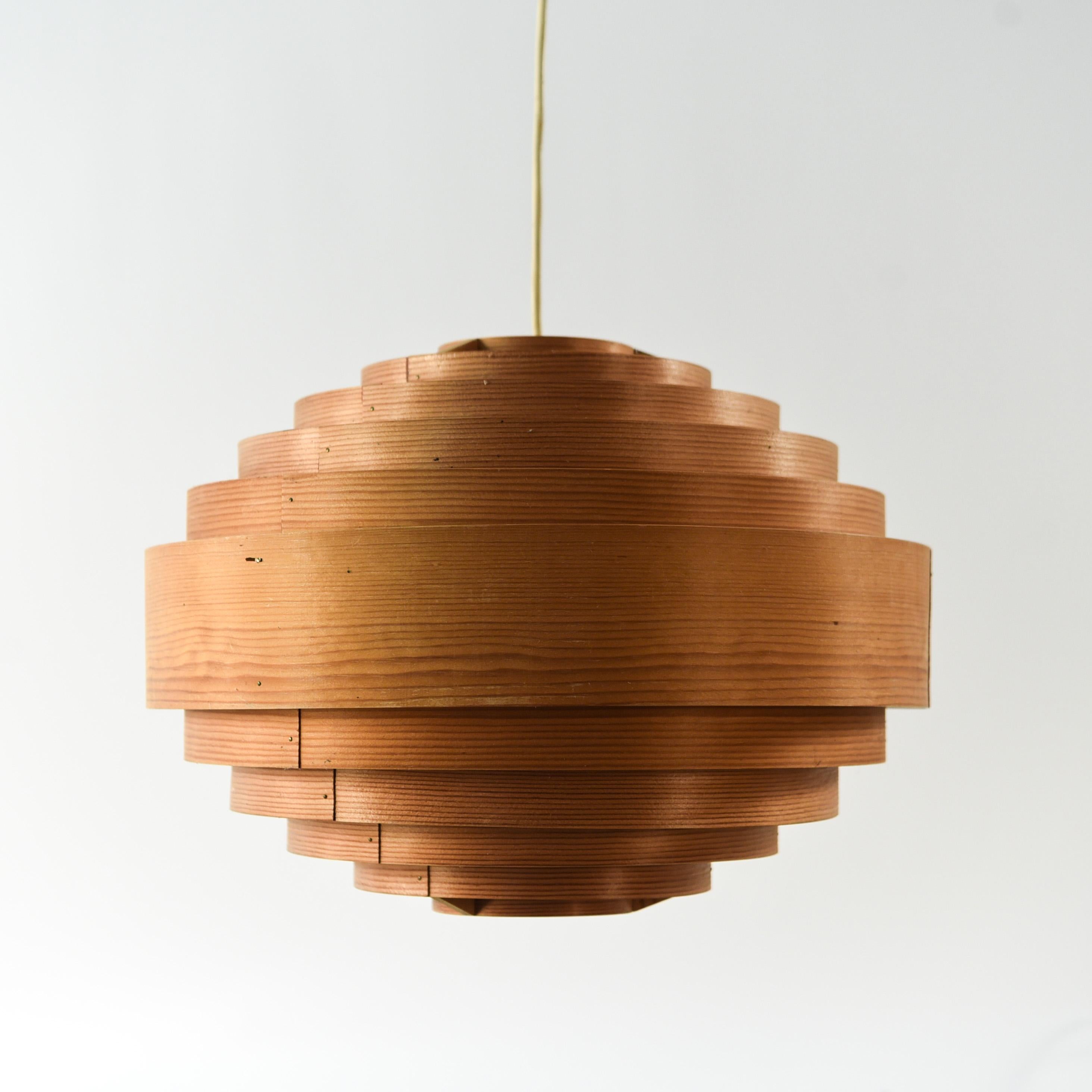 This is a rare chandelier designed by Hans Agne Jakobsson for Ellysett. This piece is made of pine wood in a stepped spherical design. This piece has a natural, warm glow when illuminated, and has a pleasing, rustic appearance even when its light is