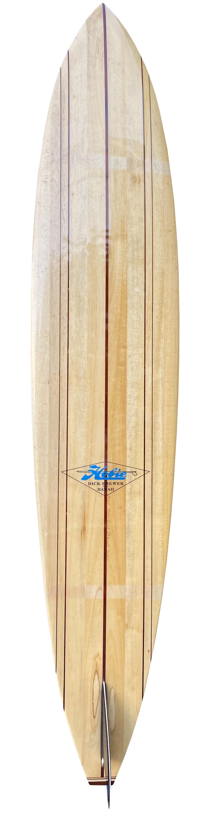 1965 model Hobie balsawood Big Wave surfboard shaped by the late Dick Brewer in 1995. Features a 5-piece redwood stringer design with 5-piece wood tailblock. Finished with a sleek low-profile fin featuring a white halo. Iconic 1965 model big wave
