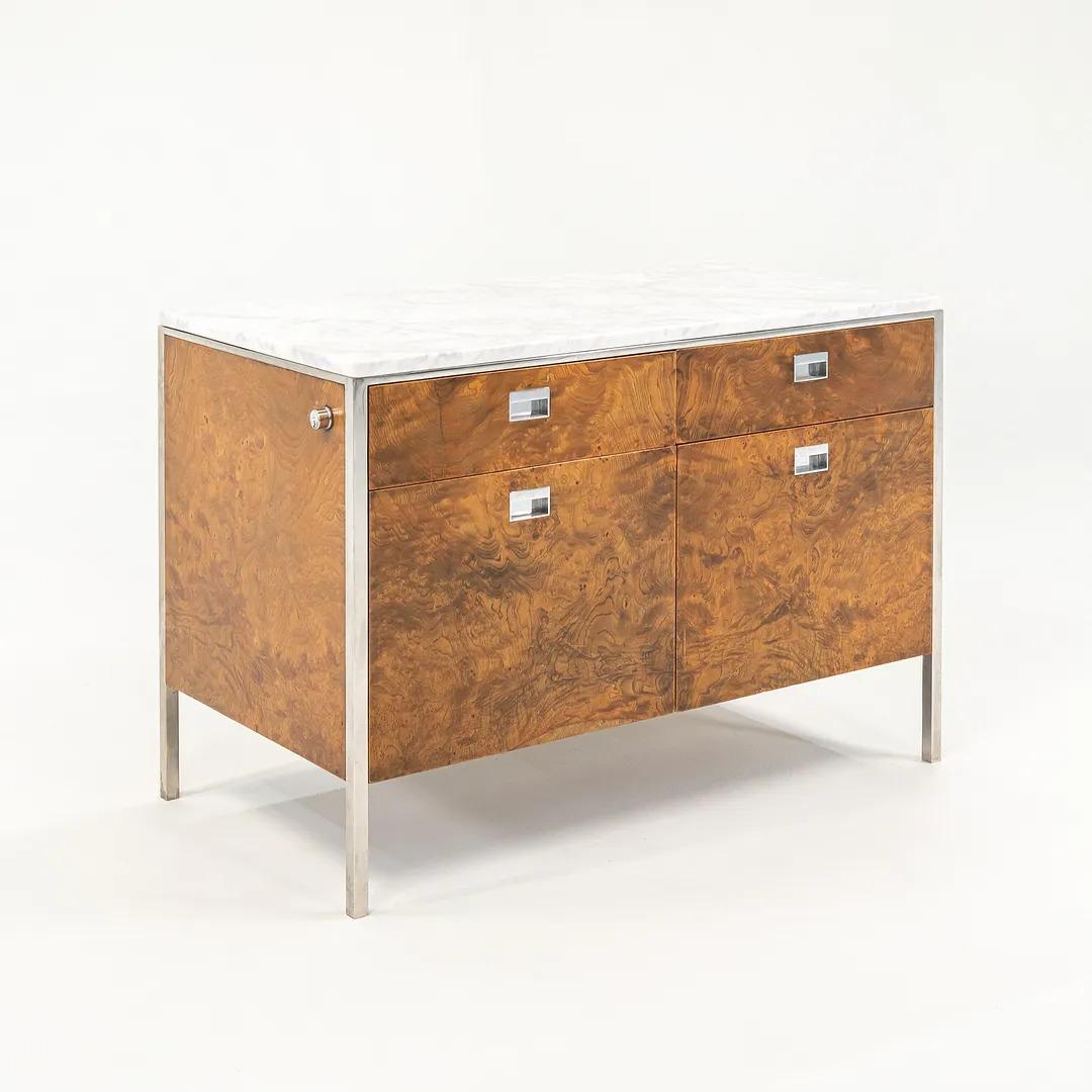 This is a monumental custom 2-position credenza, produced in 1965 by Gordon Bunshaft for the interior of the Chase Manhattan Bank headquarters, one of Bunshaft and SOM's most notable projects. It features book-matched olive ash burl throughout the