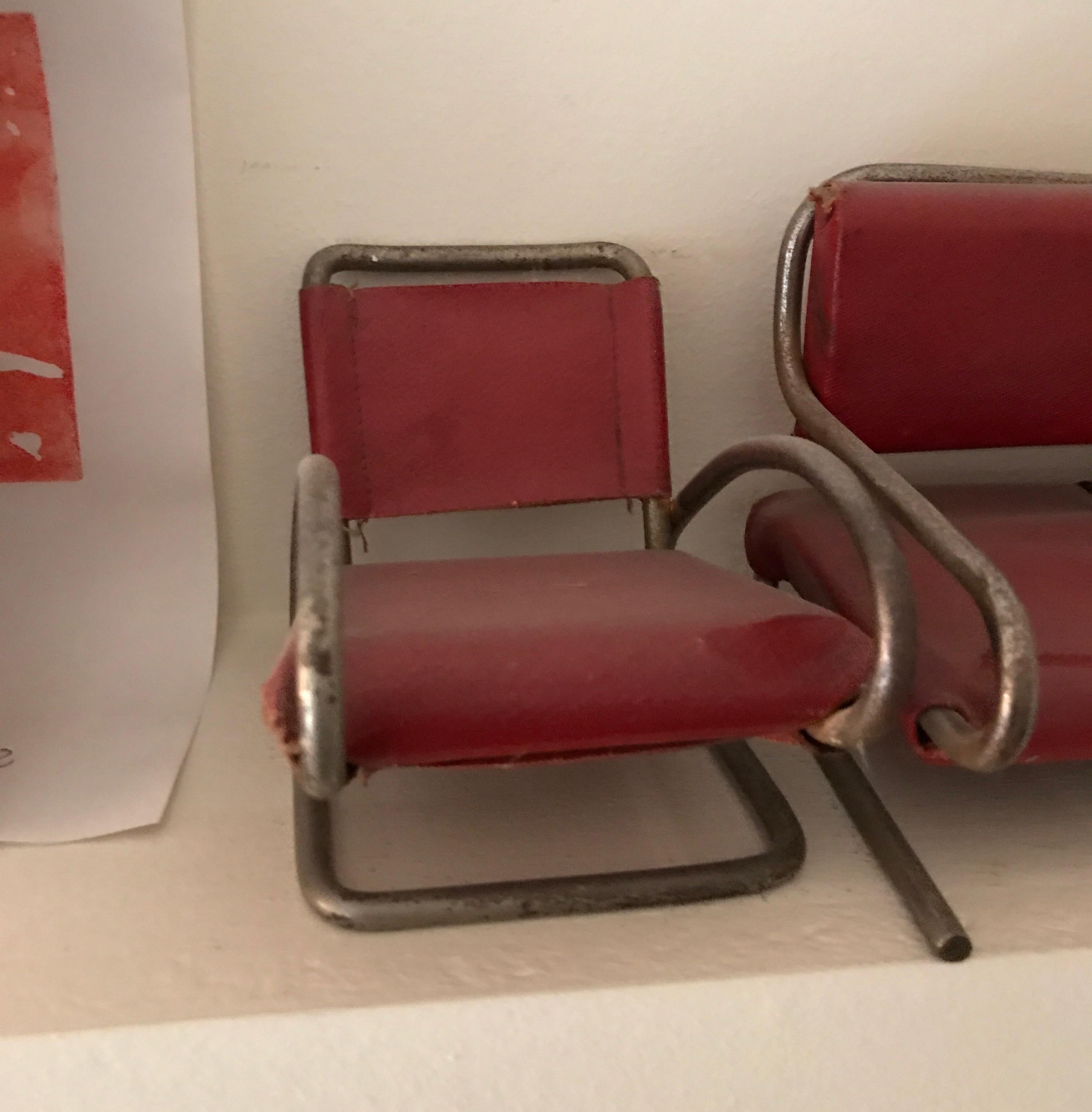 One unique set of armchairs dated circa 1965 in red skai and metal.
A little rusty.