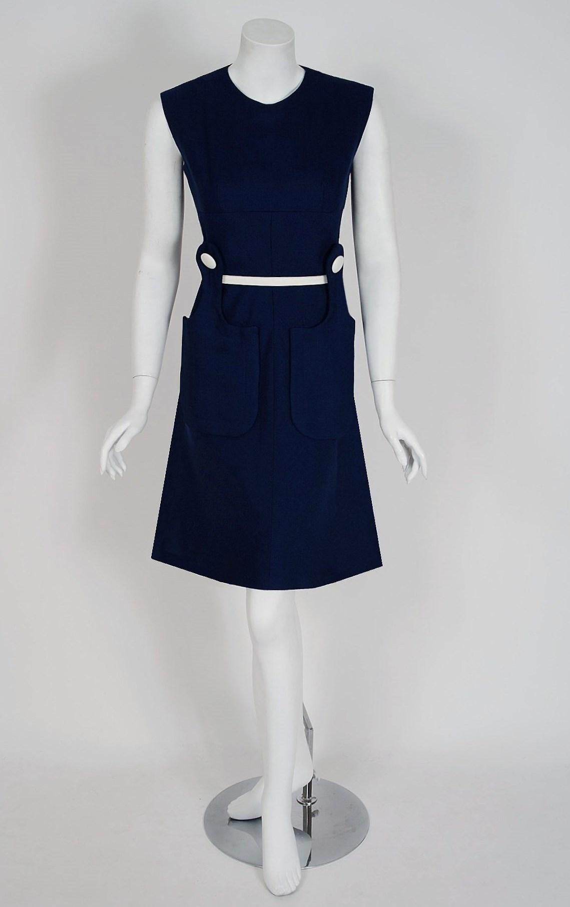 Spectacular mid 1960's Pierre Cardin designer dress in a rich navy-blue tailored linen. In 1951 Cardin opened his own couture house and by 1957, he started a ready-to-wear line; a bold move for a French couturier at the time. The look most
