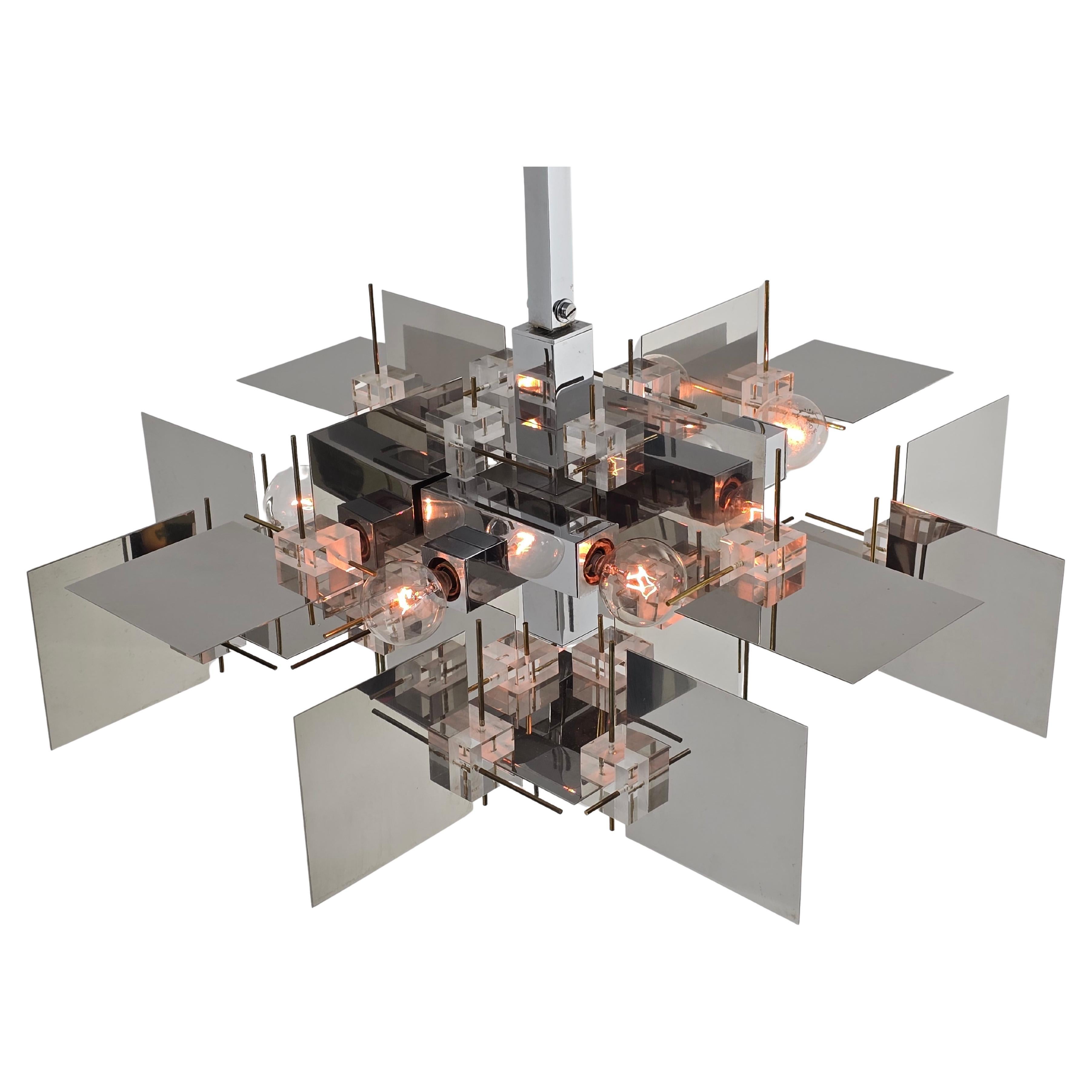 A bold , modern  Gaetano Sciolari Chandelier  made of thick polished stainless steel sheet with acrilyc cubes and brass rod . 

Well made with prime quality material. 

Solid, sturdy construction. 

Contain 9 E12 candelabra size socket rated at 40