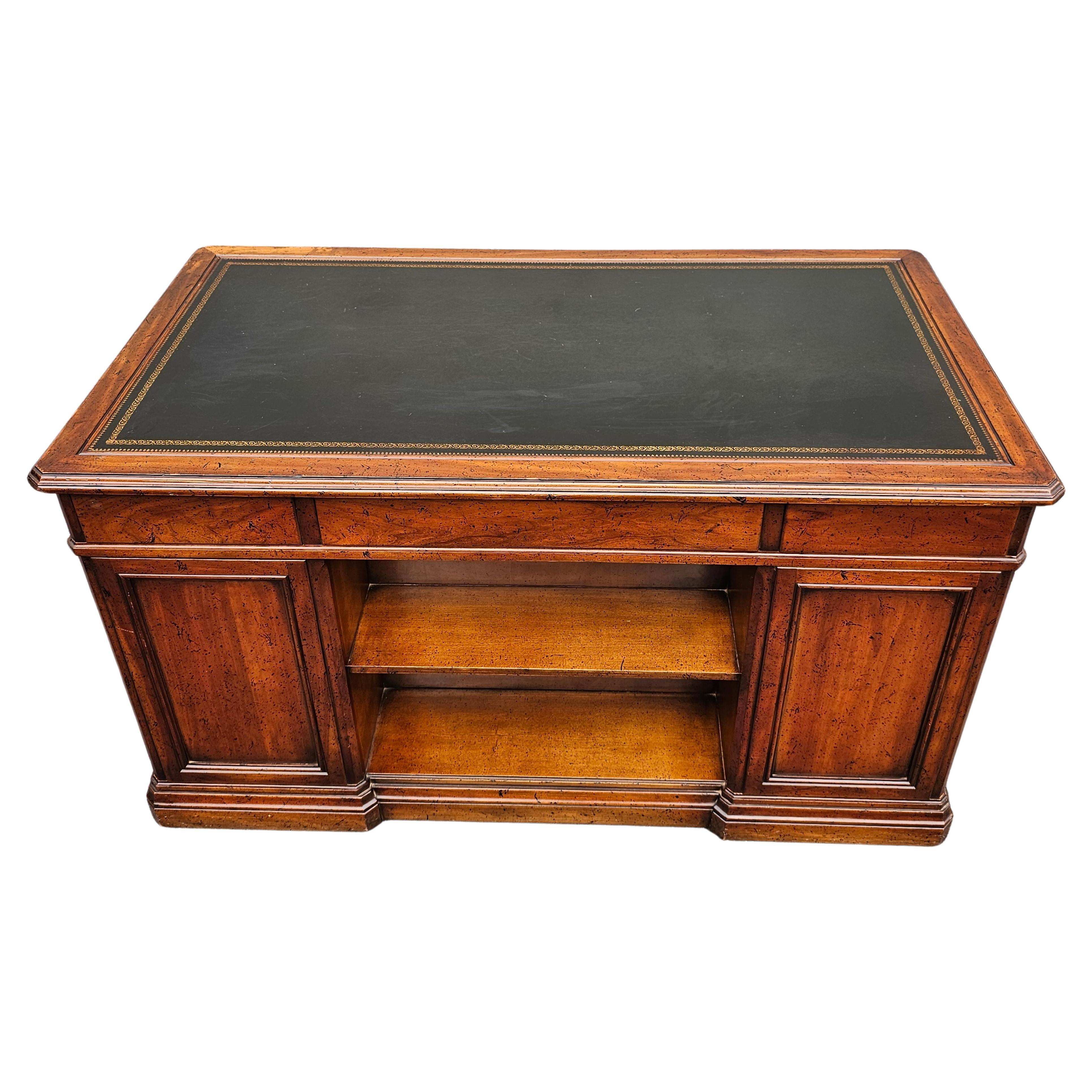 A beautiful rare Sligh Lowry Furniture Distressed Walnut and Black Tooled Letaher Top Excutive Desk Bookcase in good vintage condition. Gold stincile ornate leather top
Measures 54