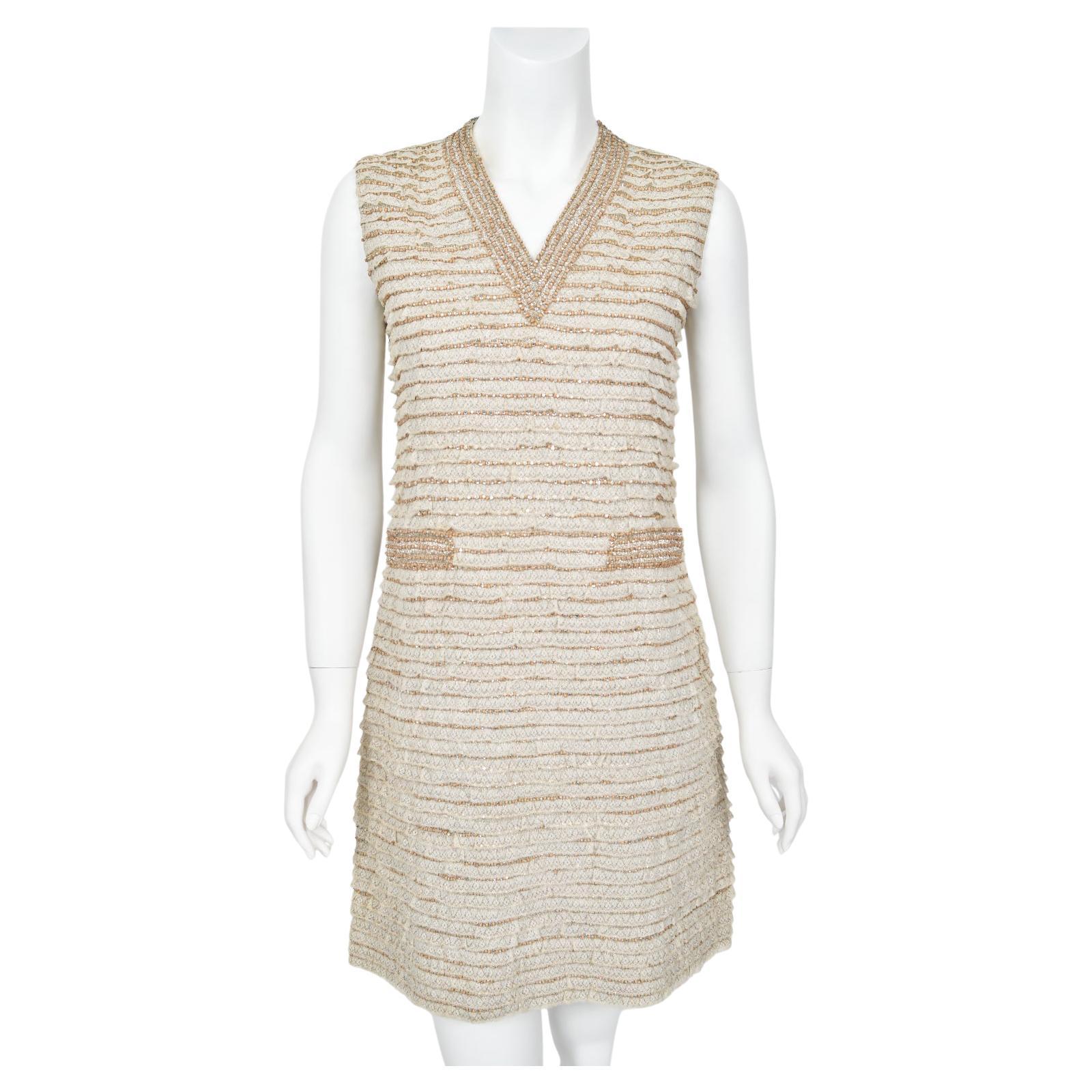 An absolutely stunning and highly coveted Valentino haute couture beaded, rhinestone-prong tiered Ivory lace mini shift dress dating back to his 1965 fall-winter collection. For over forty years, Valentino has been one of the most prominent names in