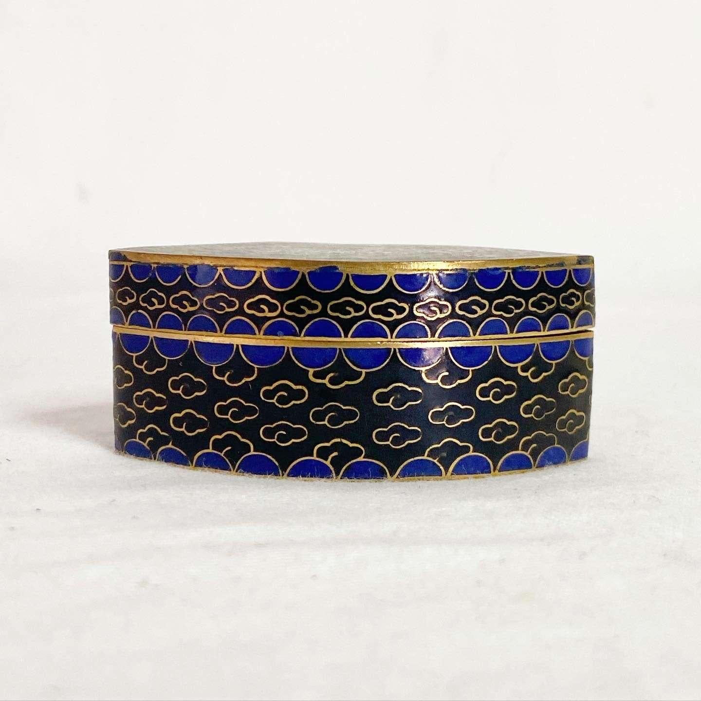Exceptional vintage Chinese style trinket box. Features an enamel design of flowers and a bird flying ever so high.
