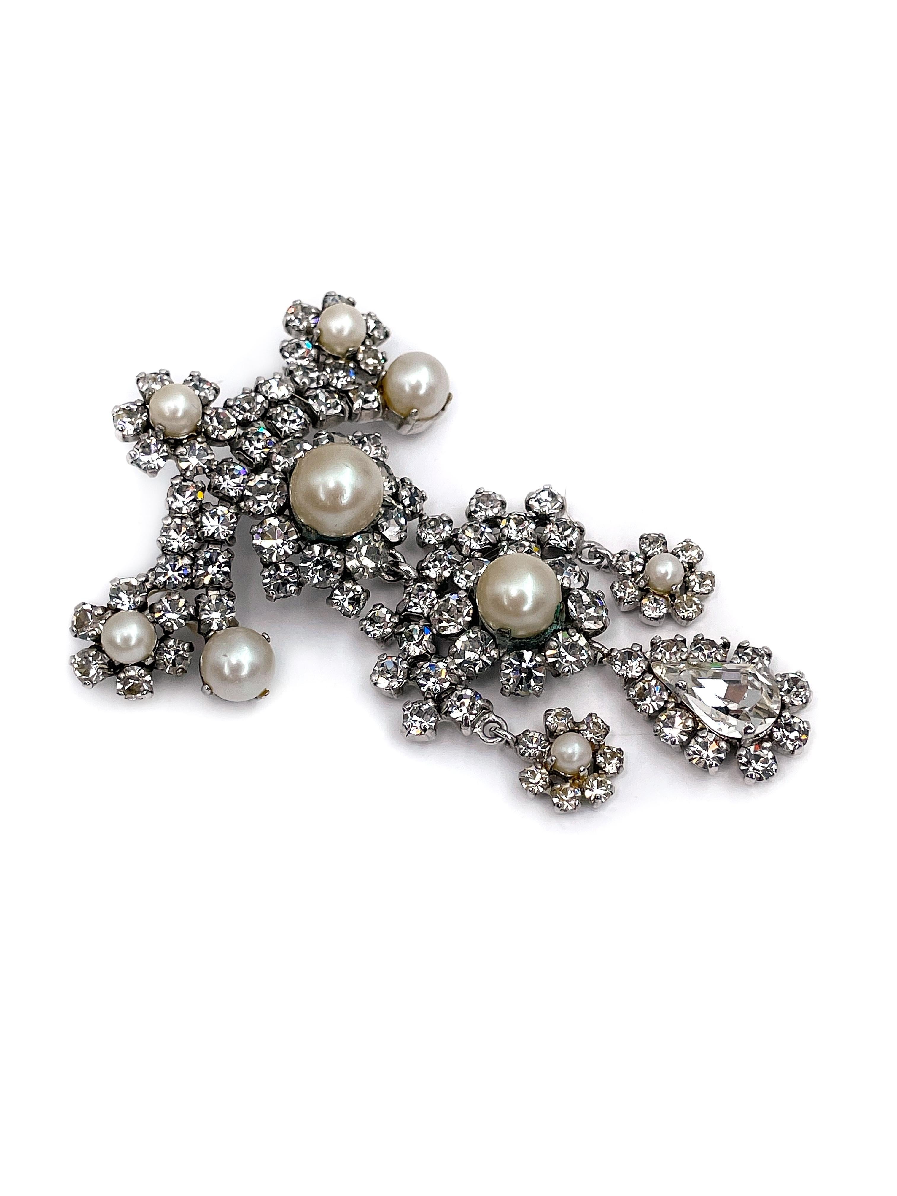 This is a magnificently sparkling silver tone chandelier pin brooch designed by Christian Dior in 1965. This piece is silver plated, adorned with faux pearls and clear shiny rhinestones.

Signature: “1965 - Chr. Dior © - Germany” (shown in