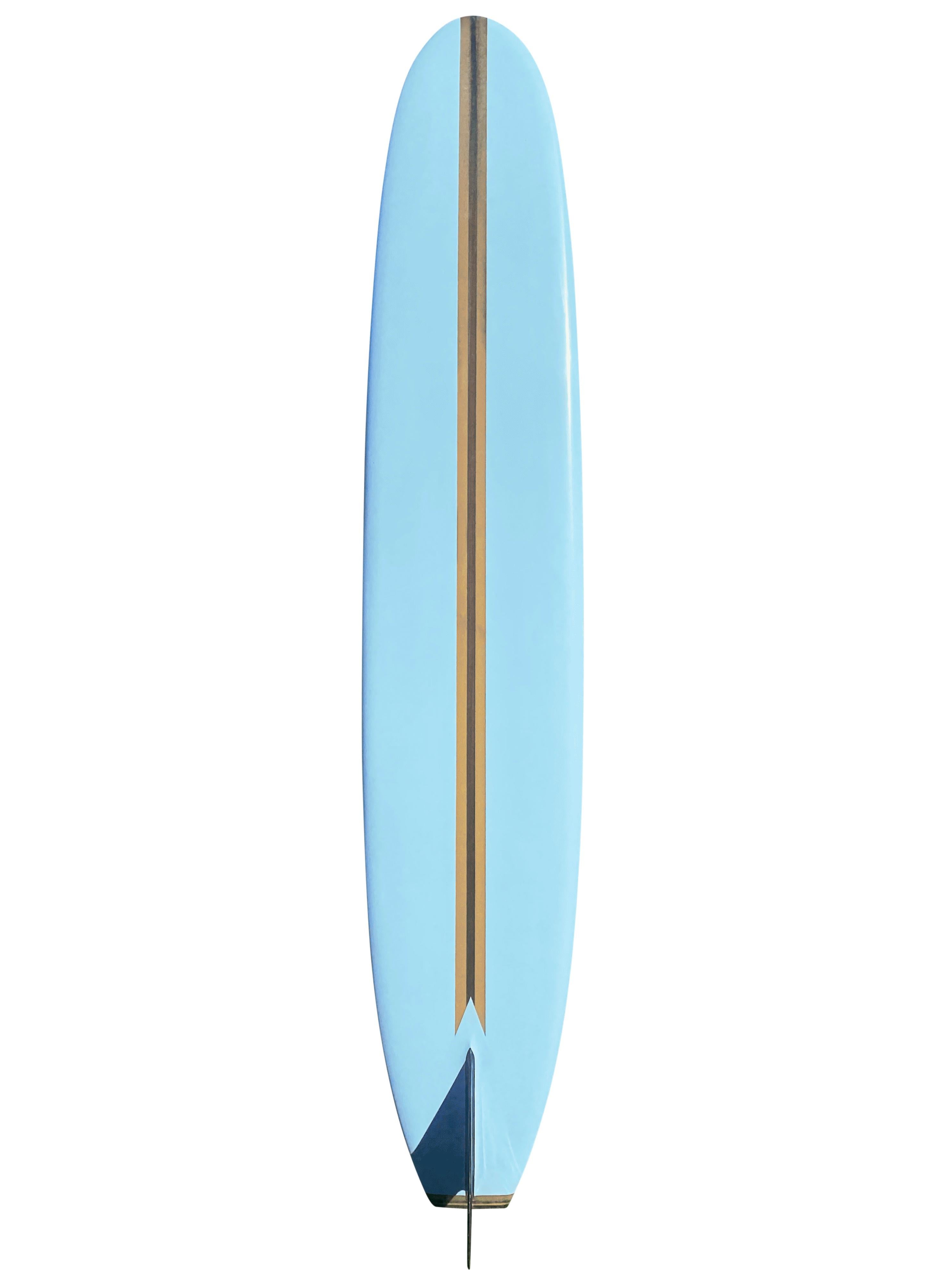 1965 Vintage Greg Noll custom longboard. Features gorgeous pastel blue color scheme with Greg Noll mid 1960s atomic logo variation. Single redwood stringer with wooden tail block and black single fin. A beautiful example of a 1960s custom longboard