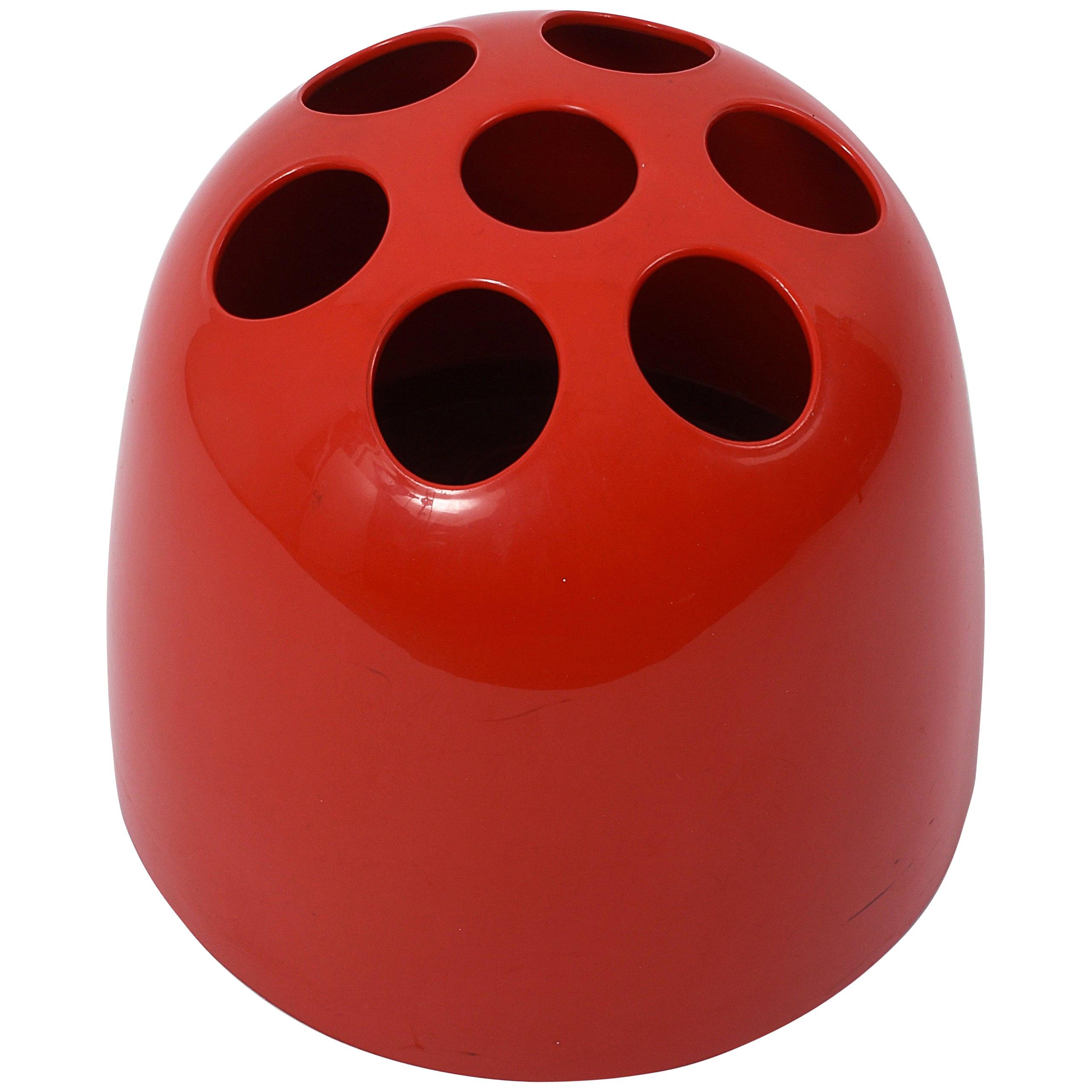 This umbrella stand, model Dedalo, was designed by Emma Gismondi Schweinberger and manufactured by Artemide in 1966. It is made from ABS plastic in red. The original object was produced in three different sizes: Small pencil holders (Dedalino),