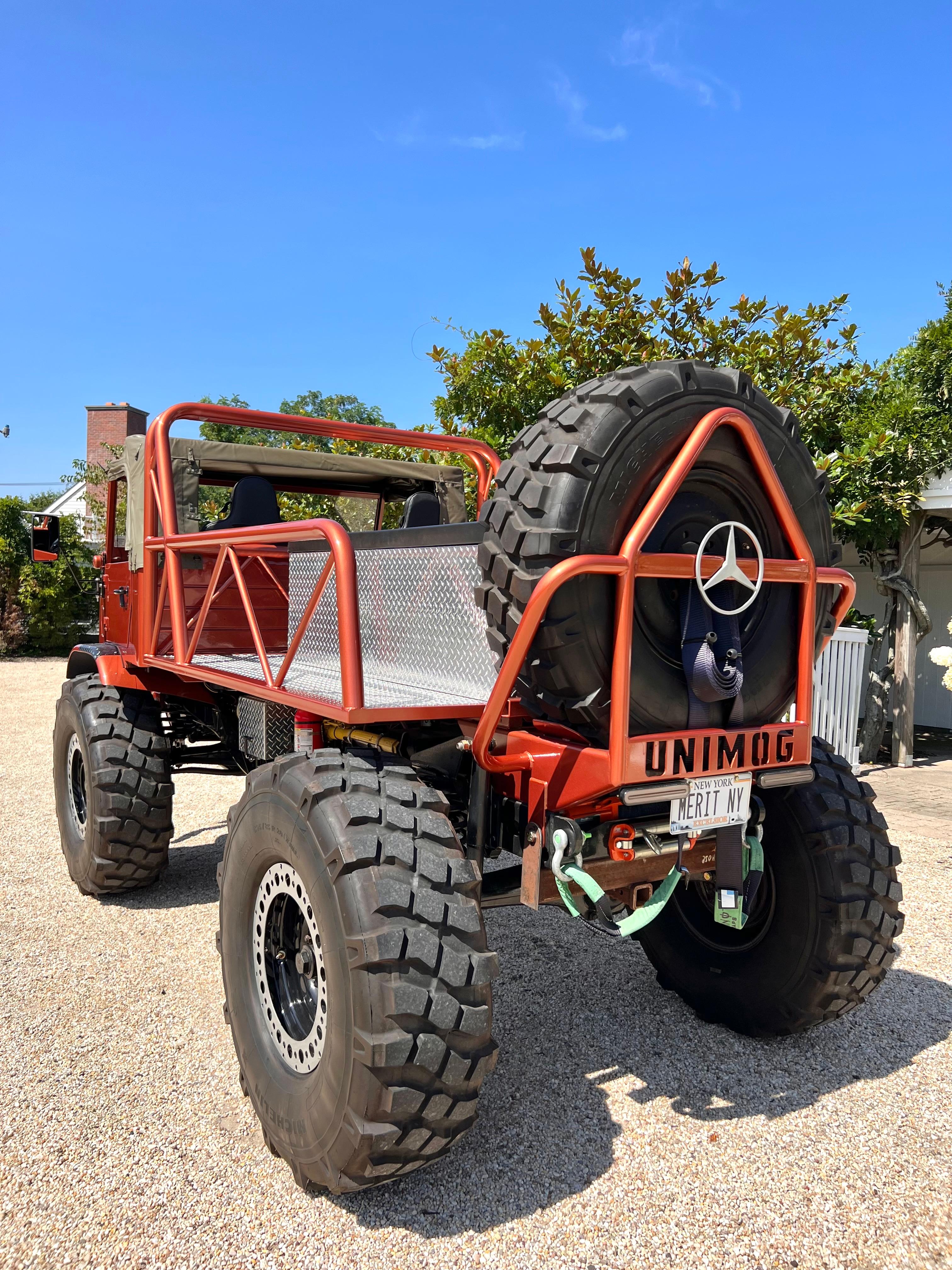 Gorgeous 1966 Mercedes Benz 404 Unimog in custom burnt orange. Original engine has been replaced with turbo diesel. 20 foot scissor lift hidden inside the bench in the truck bed. Fully operable with kill switch. Scissor lift can be operated by a