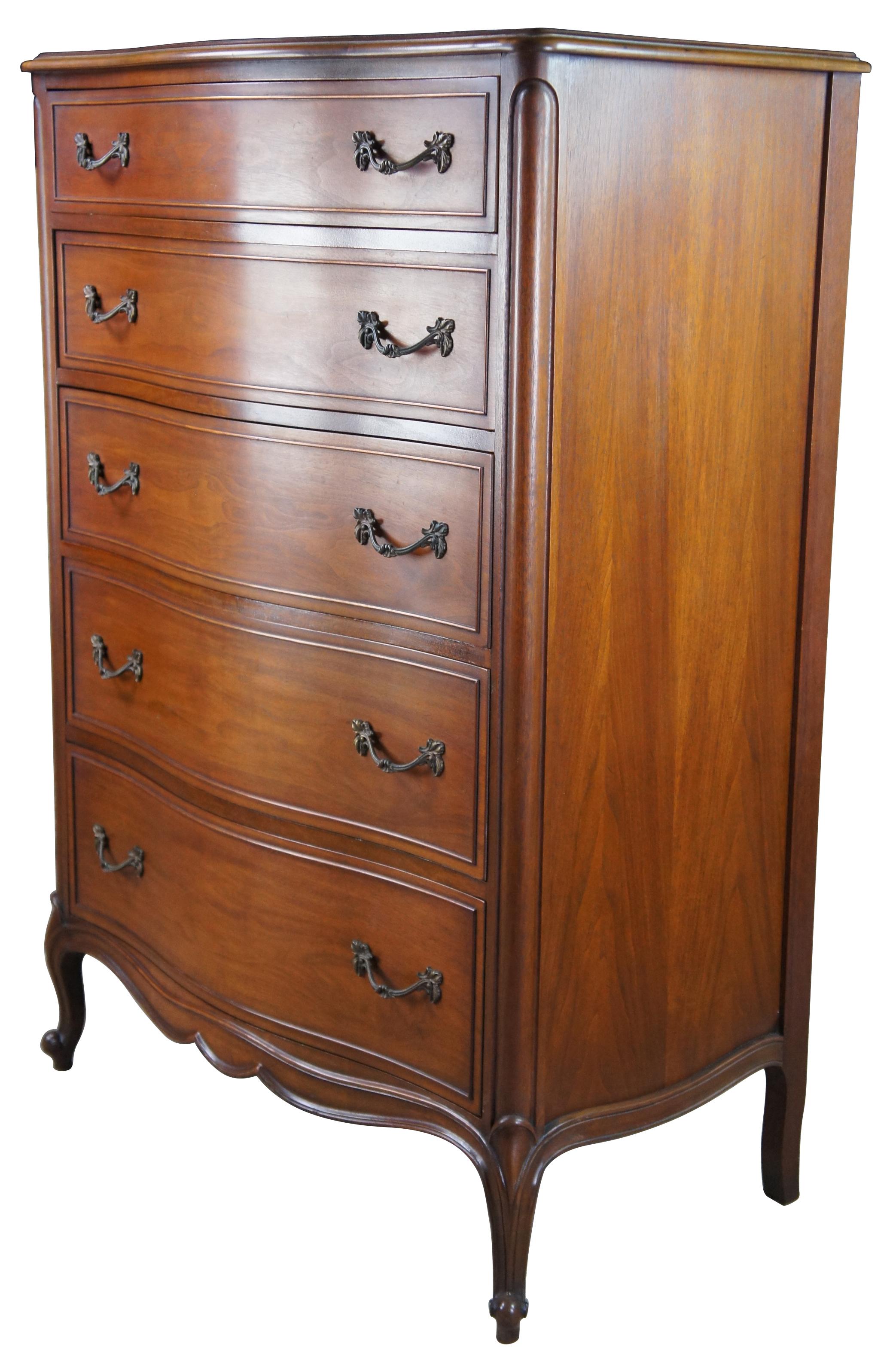 French Provincial Walnut tallboy dresser or chest by Drexel Furniture, circa 1966. Made from walnut with bordeux finish. Features a serpentine form of five drawers and cabriole legs with scrolled feet. 206-410.
    