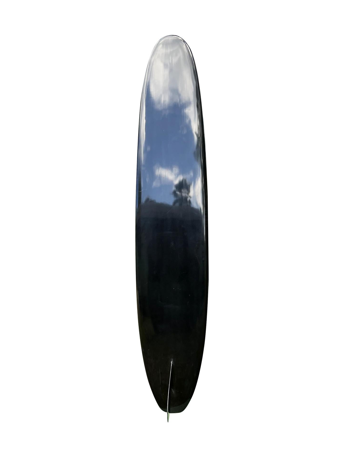 1966 Greg Noll Miki Dora ‘Da Cat’ longboard. Featuring the highly coveted 1st generation Da Cat longboard, known by it’s pronounced step deck and iconic glass-on ‘Da Cat’ style fin. Features the most prized black cat color, synonymous with the