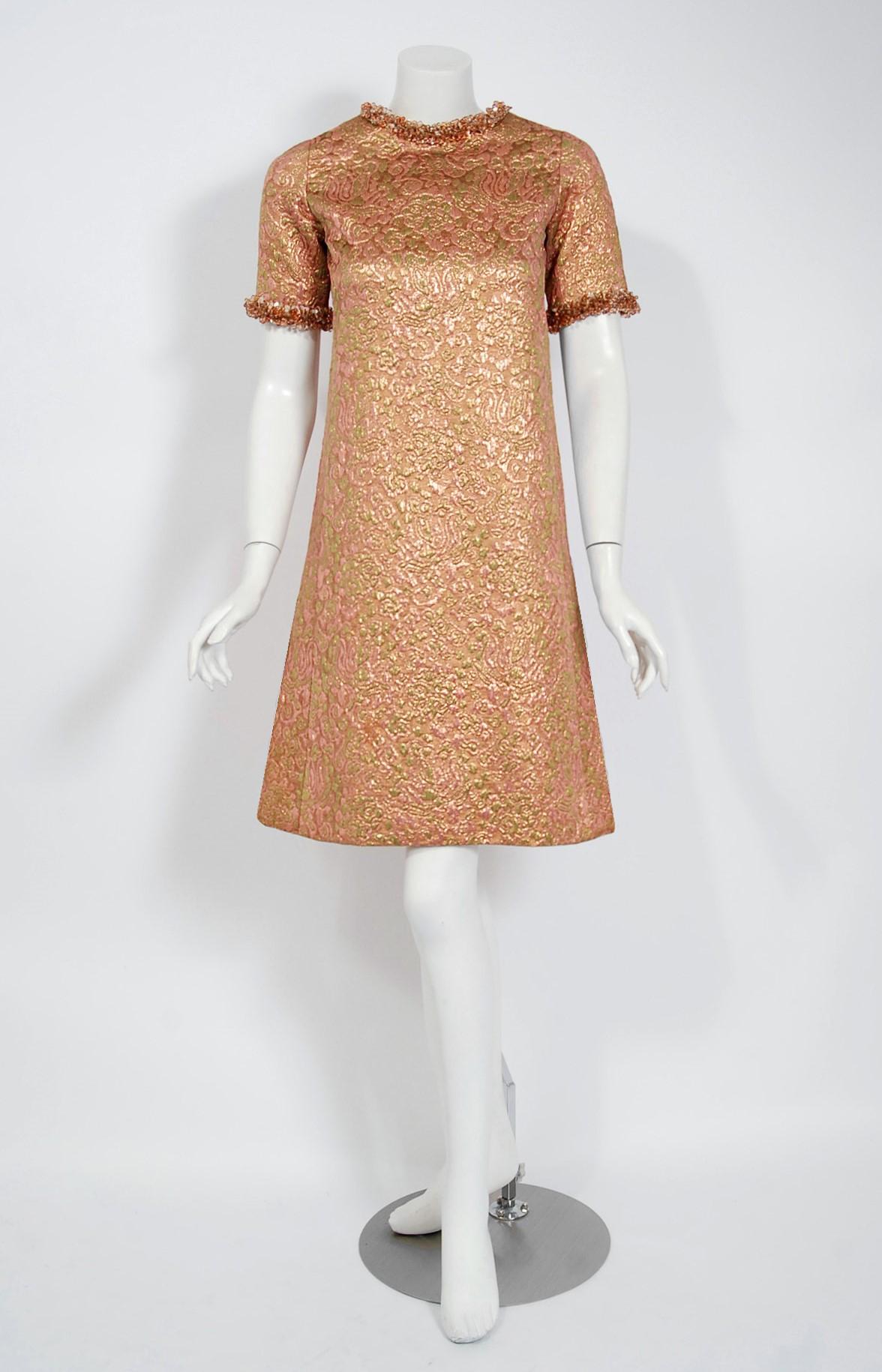 This exceptionally chic metallic silk-brocade cocktail dress is from the infamous Rive Gauche collection during Fall-Winter 1966. Pieces from this decade are very rare and are true examples of fashion history. The fabric itself is a mastepiece;