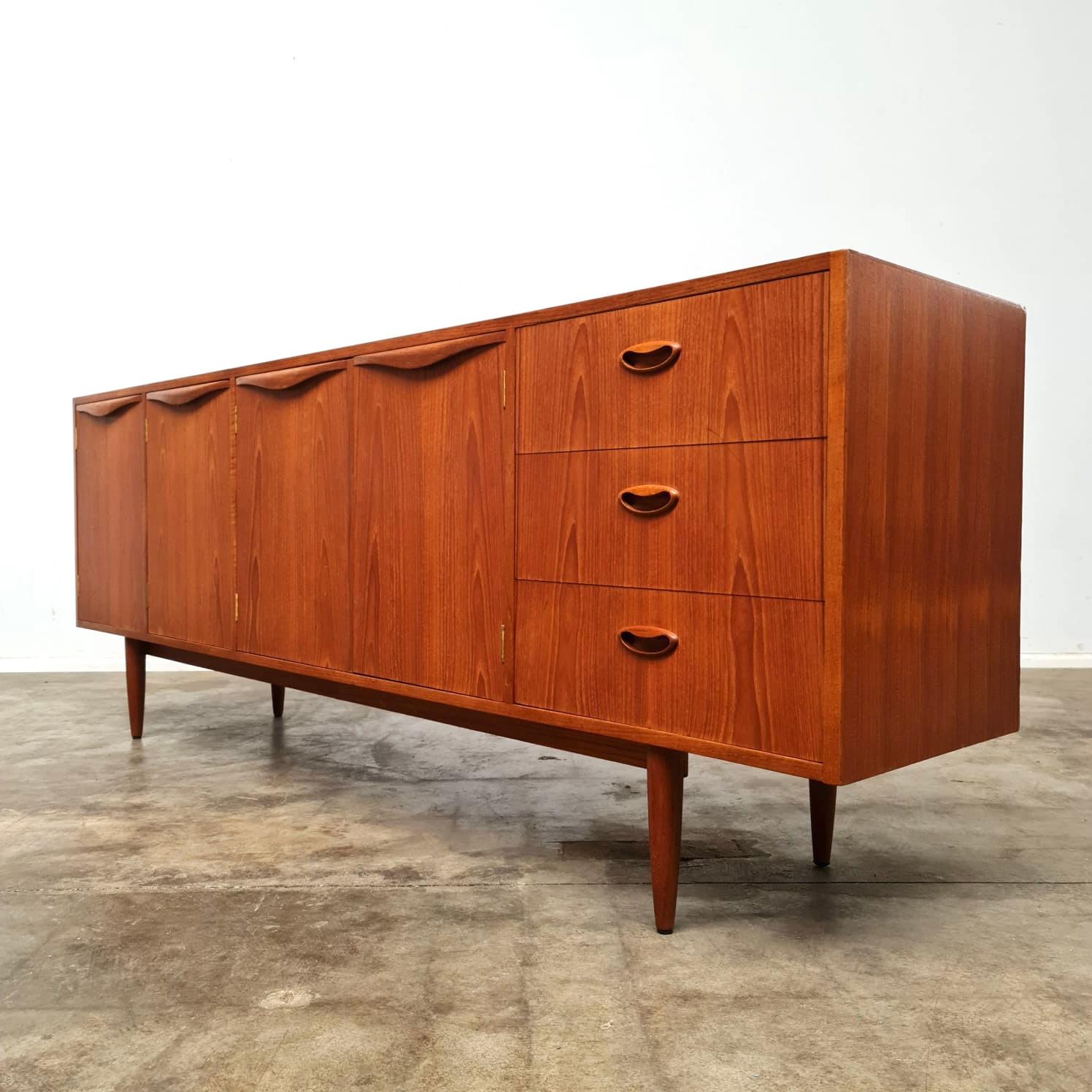 1967 Chiswell Wave Handle sideboard. Features four doors, three drawers and a cutlery drawer. Stamped 7 Sep 1967. 

This sideboard has been sanded and refinished with three coats of satin hardwax oil. presents very well with a few small repairs