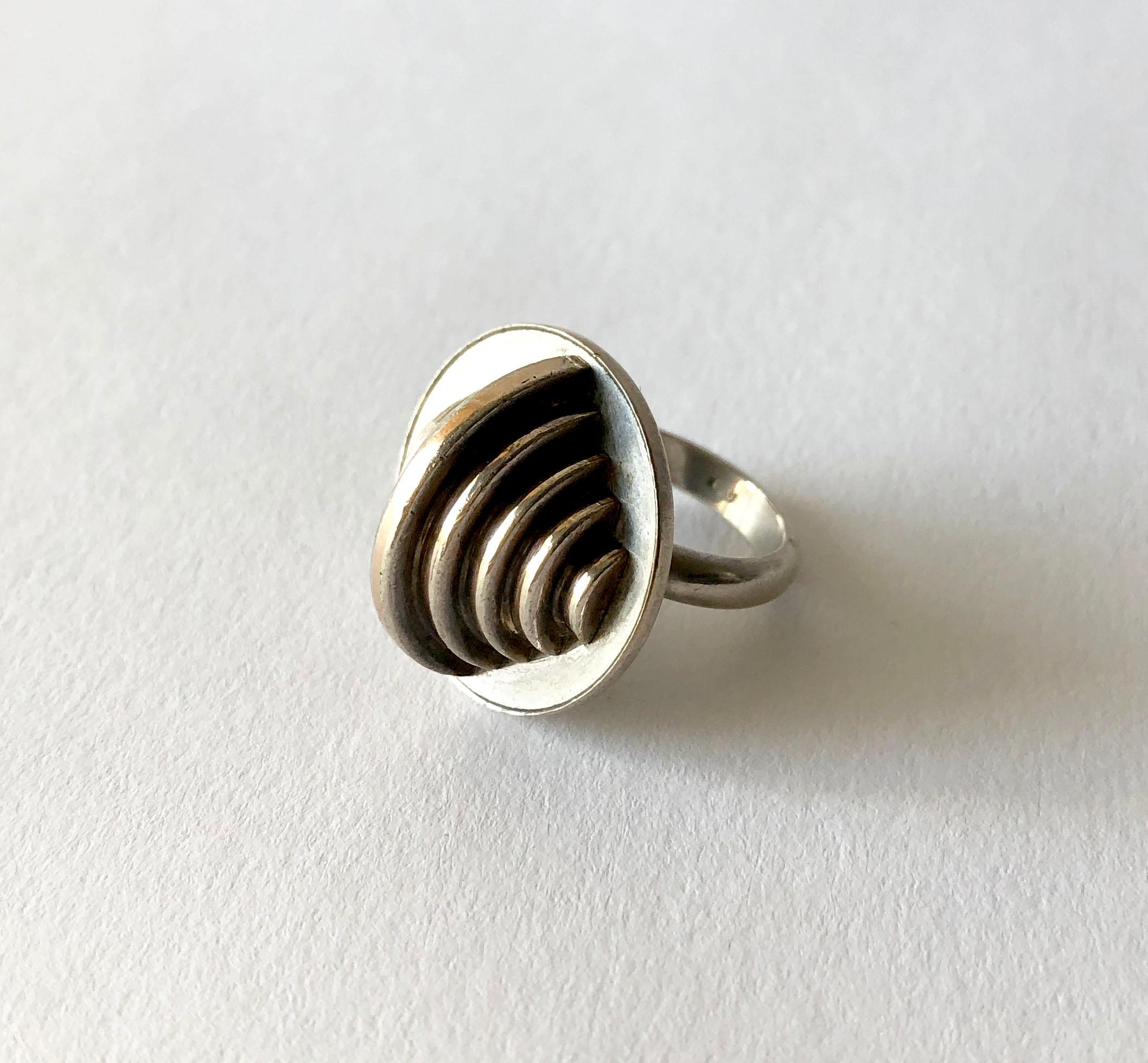 Rhodium plated silver geometric modernist ring created by Edival Ramosa (1940 - 2015) of Brazil and produced by Gem Montebello, the Italian firm who collaborated with many visual artists of the time.  Ring is a finger size 5.5 and is signed with the