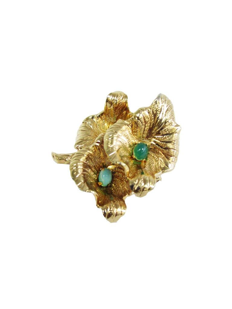 
Incredibly detailed brooch by Grosse! The brooch features three textured gold flowers with green Aventurine stones known as friendship stones. A simple but fun brooch to add a little decoration to whatever you see fit!

Grosse of Germany made both