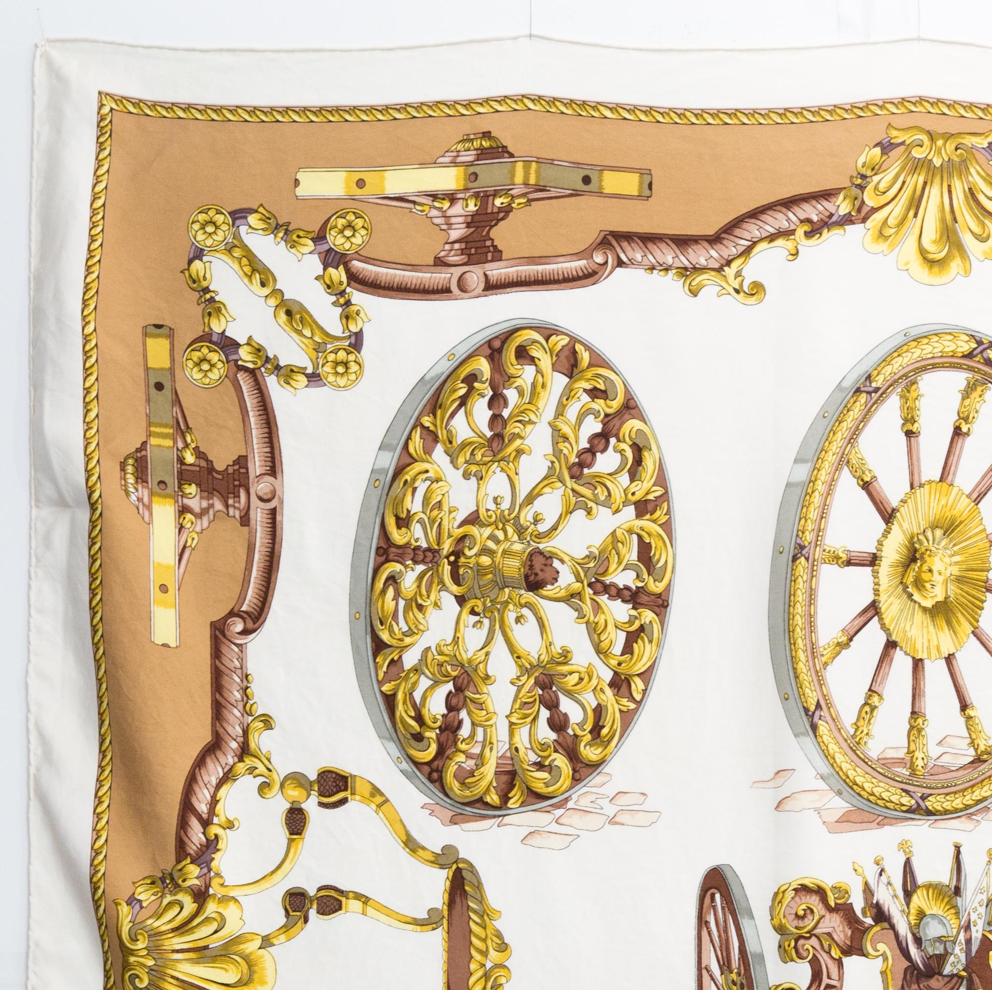 1967, rare Hermes Les Roues de Canon by Caty Silk Scarf featuring an ivory ground and a Hermès signature. 
Designed in 1967.
In good vintage condition. Made in France.
35,4in. (90cm)  X 35,4in. (90cm)
We guarantee you will receive this  iconic item