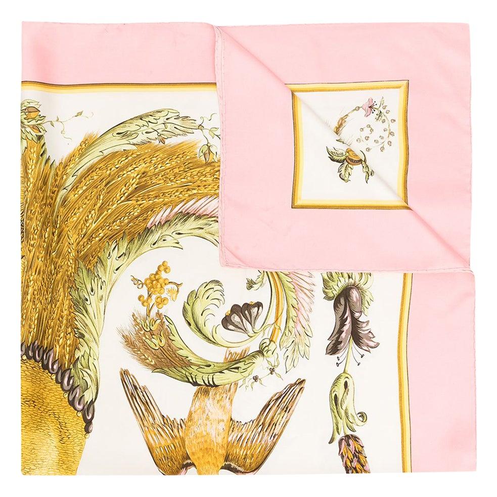 Hermes silk scarf Ceres by Françoise Faconnet featuring a light pink border and a Hermès signature. 
First edition in 1967
In good vintage condition. Made in France.
35,4in. (90cm)  X 35,4in. (90cm)
We guarantee you will receive this  iconic item as