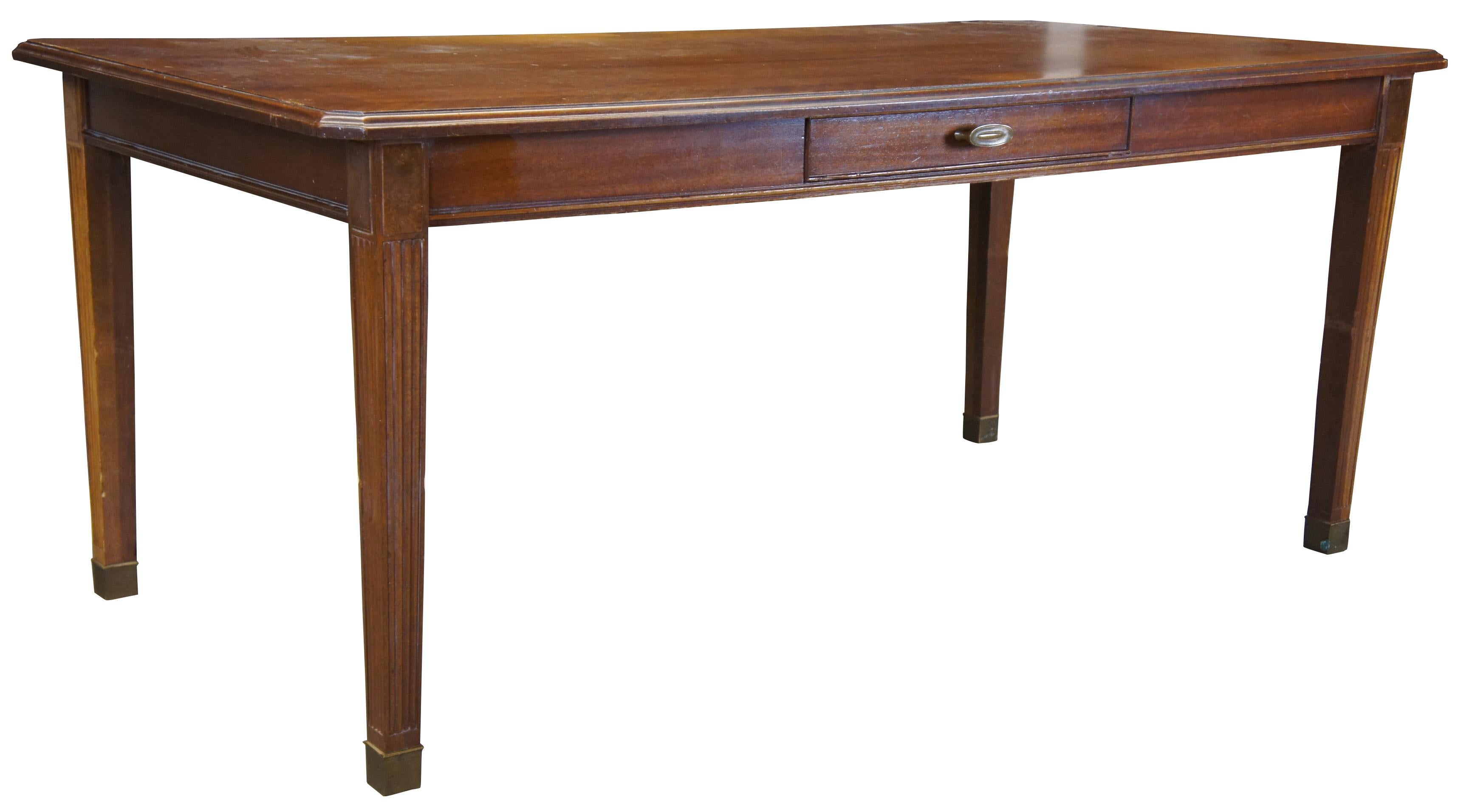 Midcentury library table by Drexel Furniture Company. Made October 1968. Features a traditional design, made from walnut with banded top, a drawer on each side, burl wood accents and square tapered legs with fluting leading to brass caps. Measures: