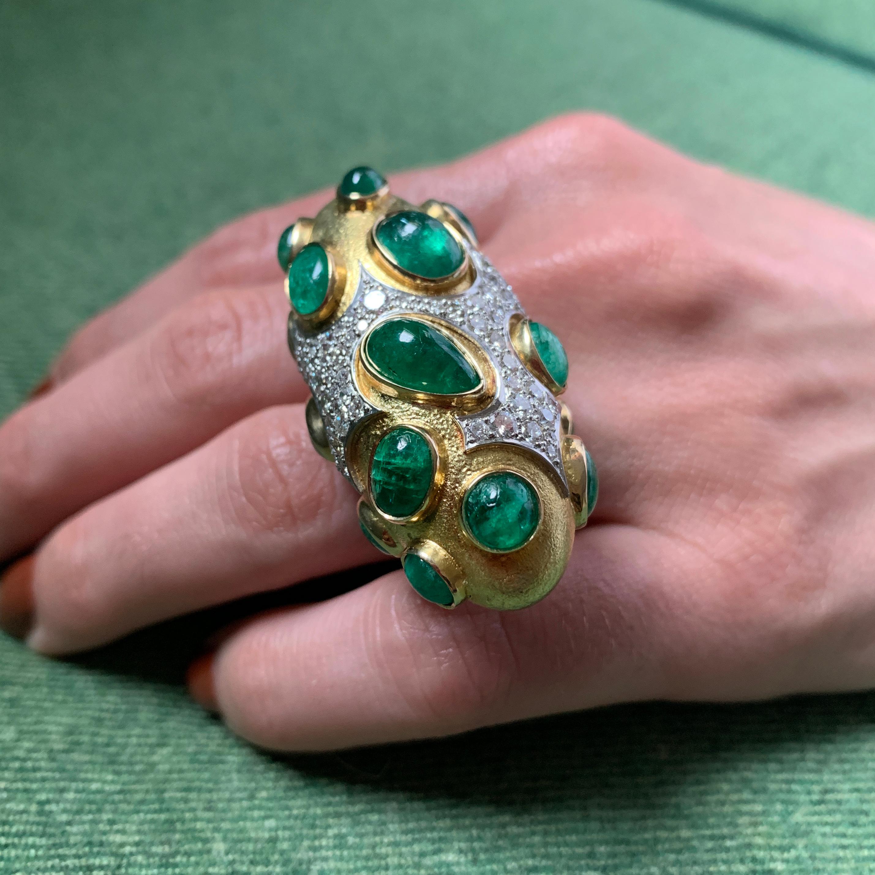 A large ring of Colombian emerald, diamond, and 18 karat yellow gold, by Roger Lucas, 1968, Canada. In its original box. The emerald cabochons have an estimated total weight of 16.00 - 18.00 carats. The round brilliant cut diamonds have an estimated