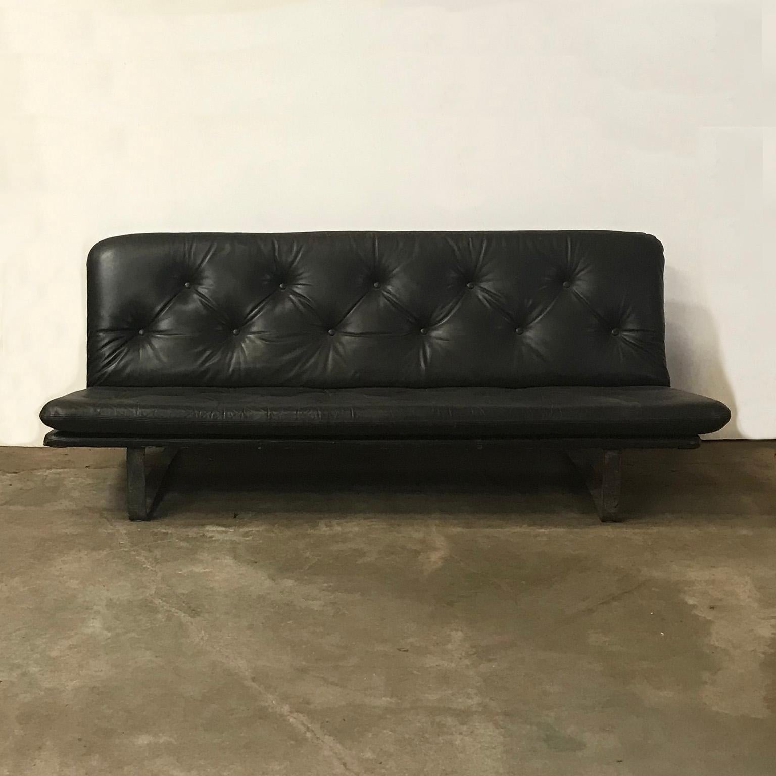 Original, early, stronger manufactured as nowadays, Kho Liang Ie 3-seat padded sofa in dark brown (soft) leather and Black base. The sofa has a great look because of the traces of wear of the leather that gives it a strong character. There is a long