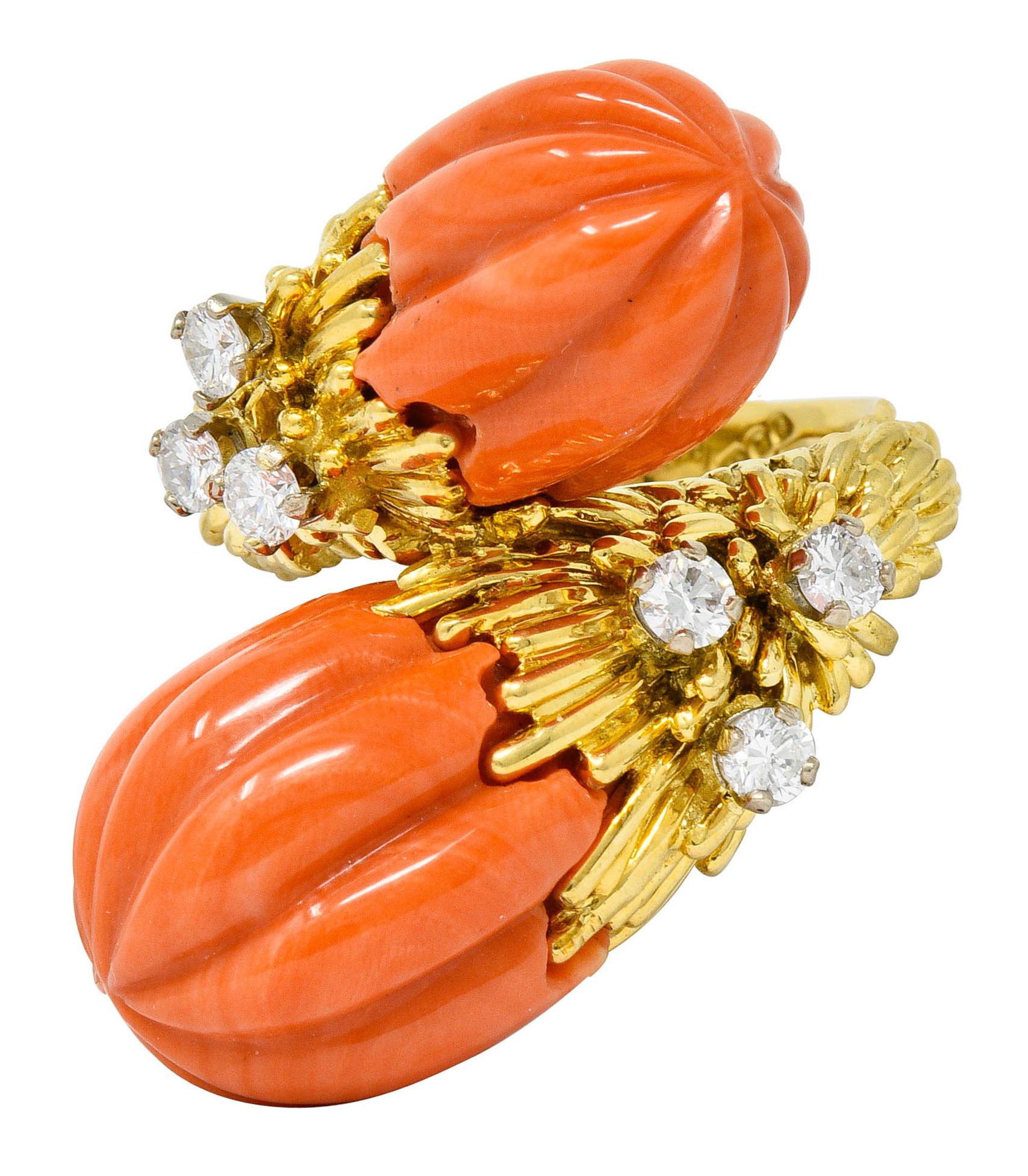 Bypass style ring terminating as two pampel shaped coral with deeply carved fluting

Well-matched with peachy-orange color and exhibits very slight swirled color distribution

Accented by round brilliant cut diamonds weighing approximately 0.60